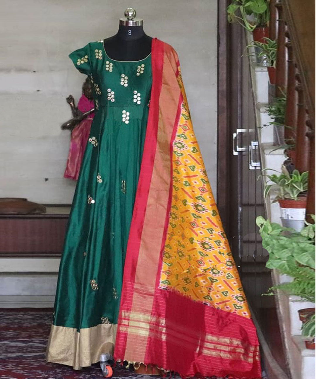 Adorable Anarkali gown with intricate mirror embroidery, paired with a silk dupatta for a stunning ensemble.