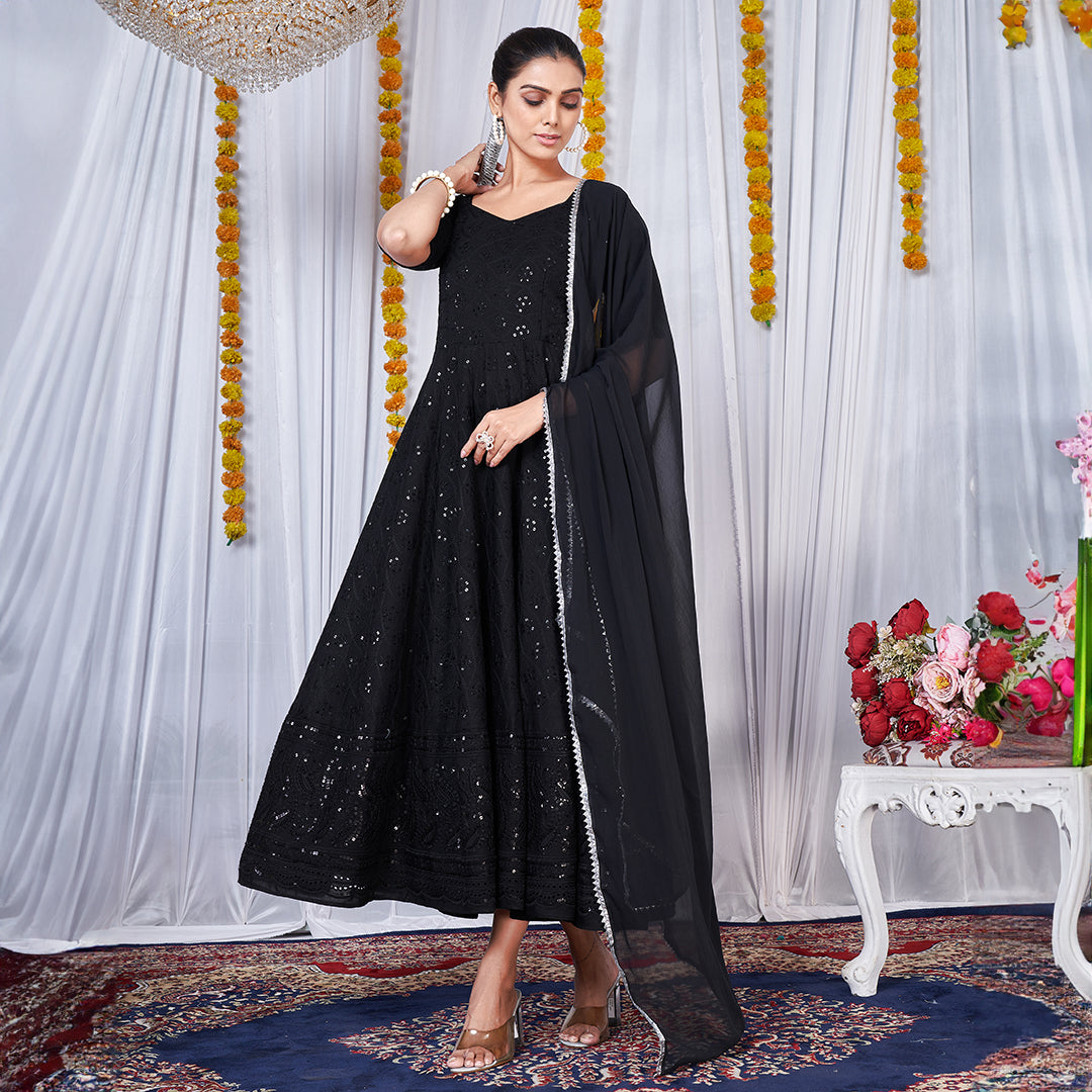 A black gown featuring intricate Chikankari and embroidery work.
