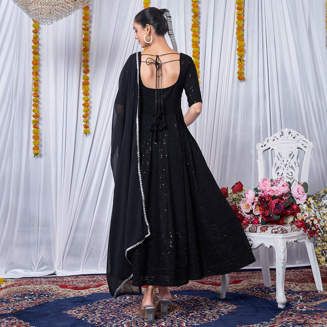 A black gown featuring intricate Chikankari and embroidery work.