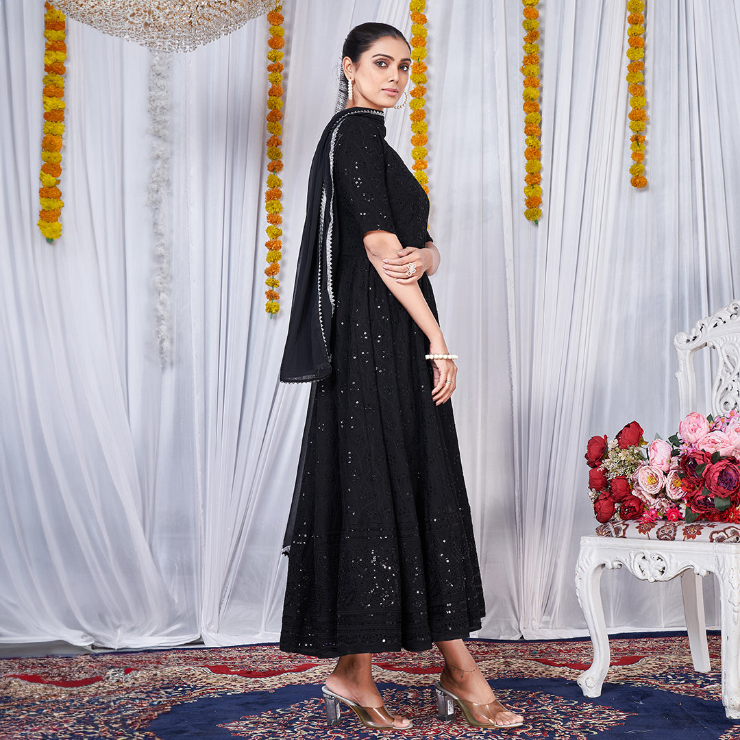 A black gown featuring intricate Chikankari and embroidery work.