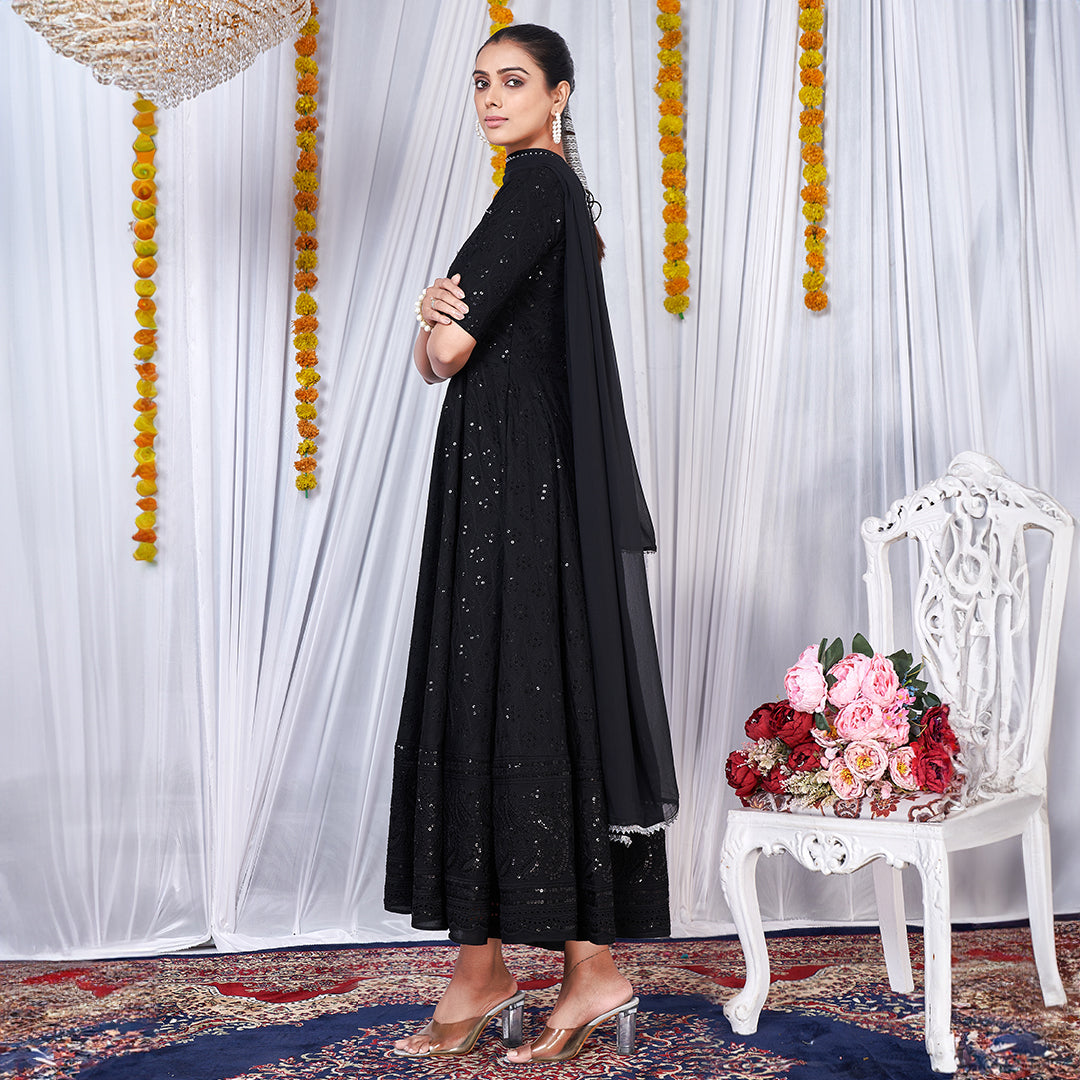 A black gown featuring intricate Chikankari and embroidery work.