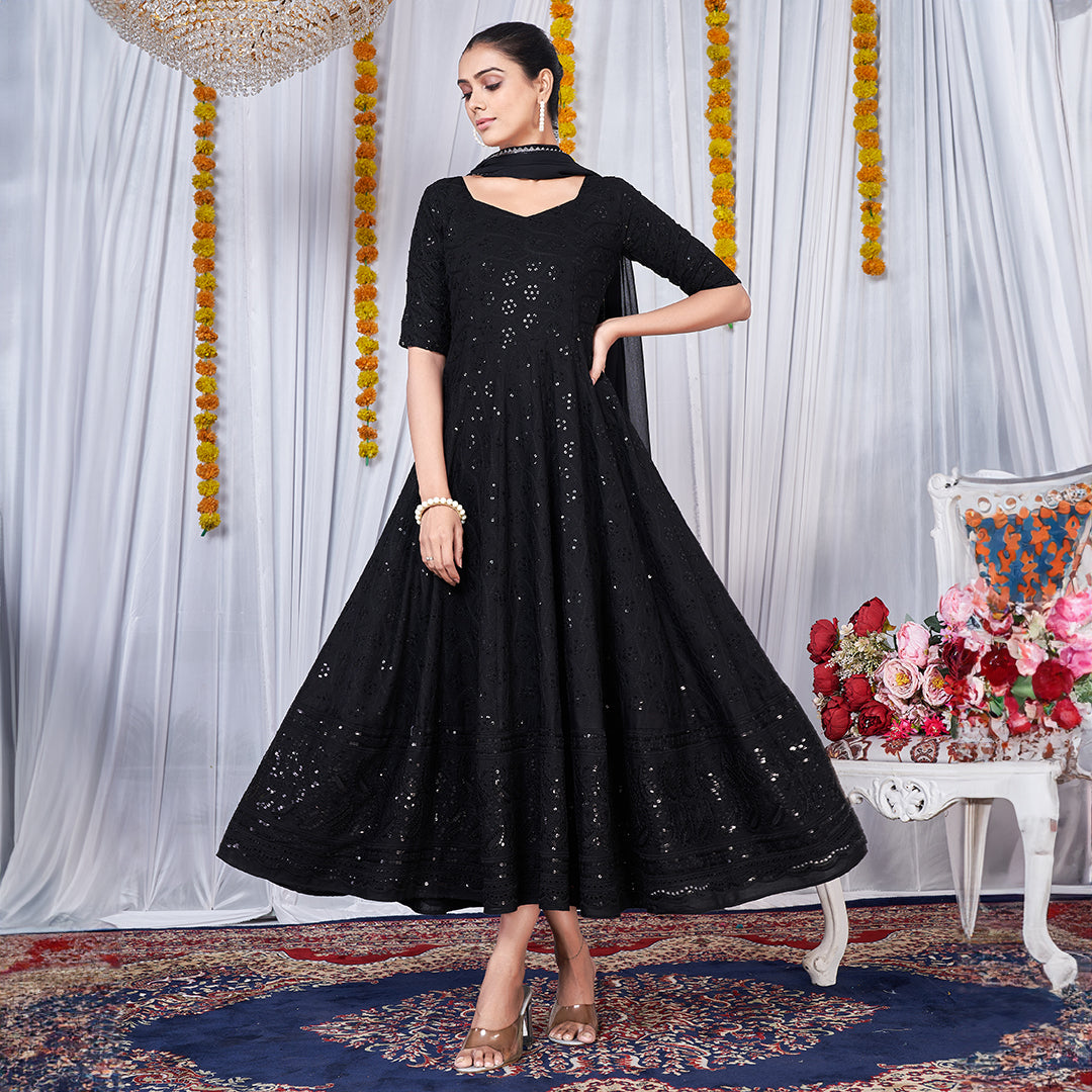 A black gown featuring intricate Chikankari and embroidery work.