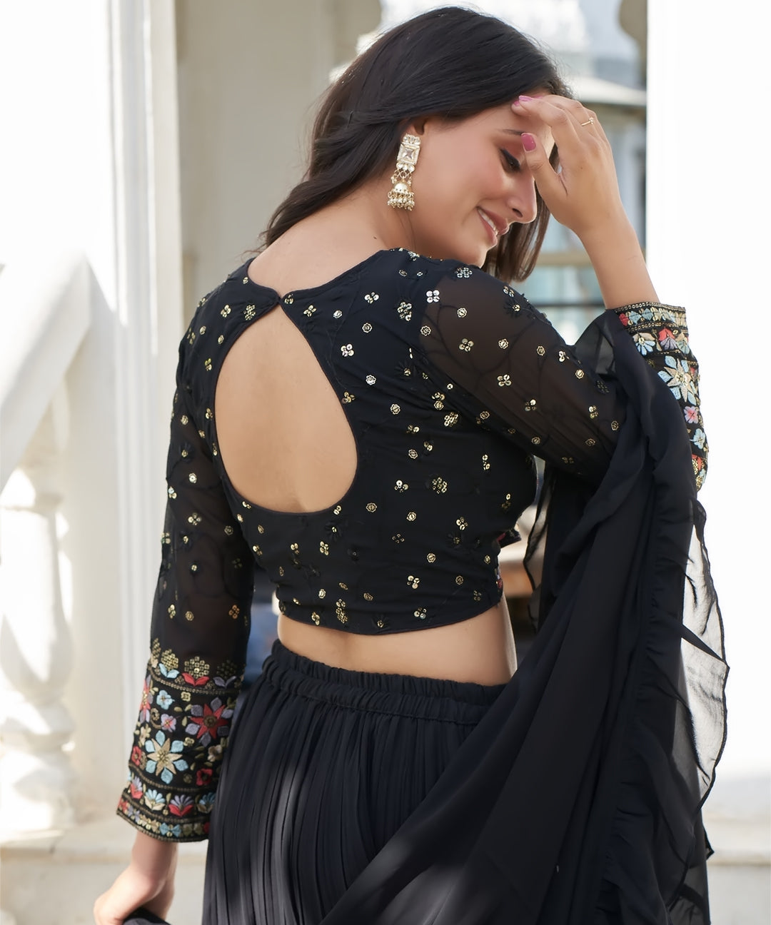 Black tiered lehenga choli with matching dupatta, featuring a stylish layered design and elegant detailing