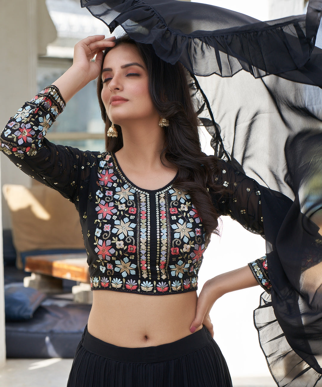 Black tiered lehenga choli with matching dupatta, featuring a stylish layered design and elegant detailing