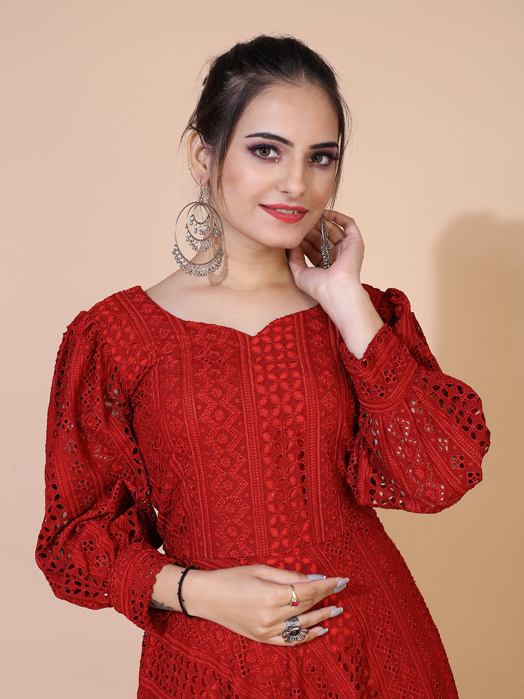 A timeless maroon gown adorned with traditional Lucknowi embroidery, featuring a graceful floor-length silhouette.