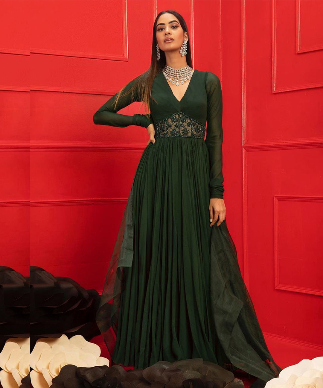 Dark green Anarkali gown with V-neckline, handwork panel at the waist, and full sleeves, ideal for elegant and traditional events.