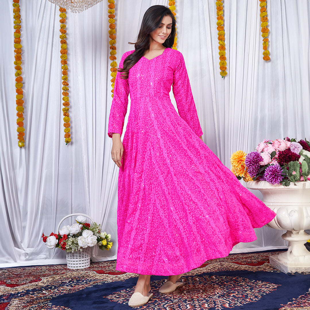 A dark pink georgette gown adorned with intricate Lucknowi embroidery.