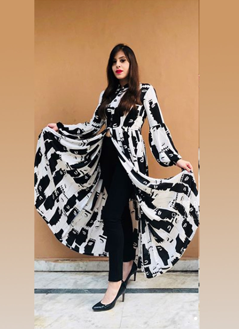 A stunning designer kurti featuring a printed front, a stylish front slit, and a flowing silhouette that reaches the floor. Made from comfortable rayon fabric.