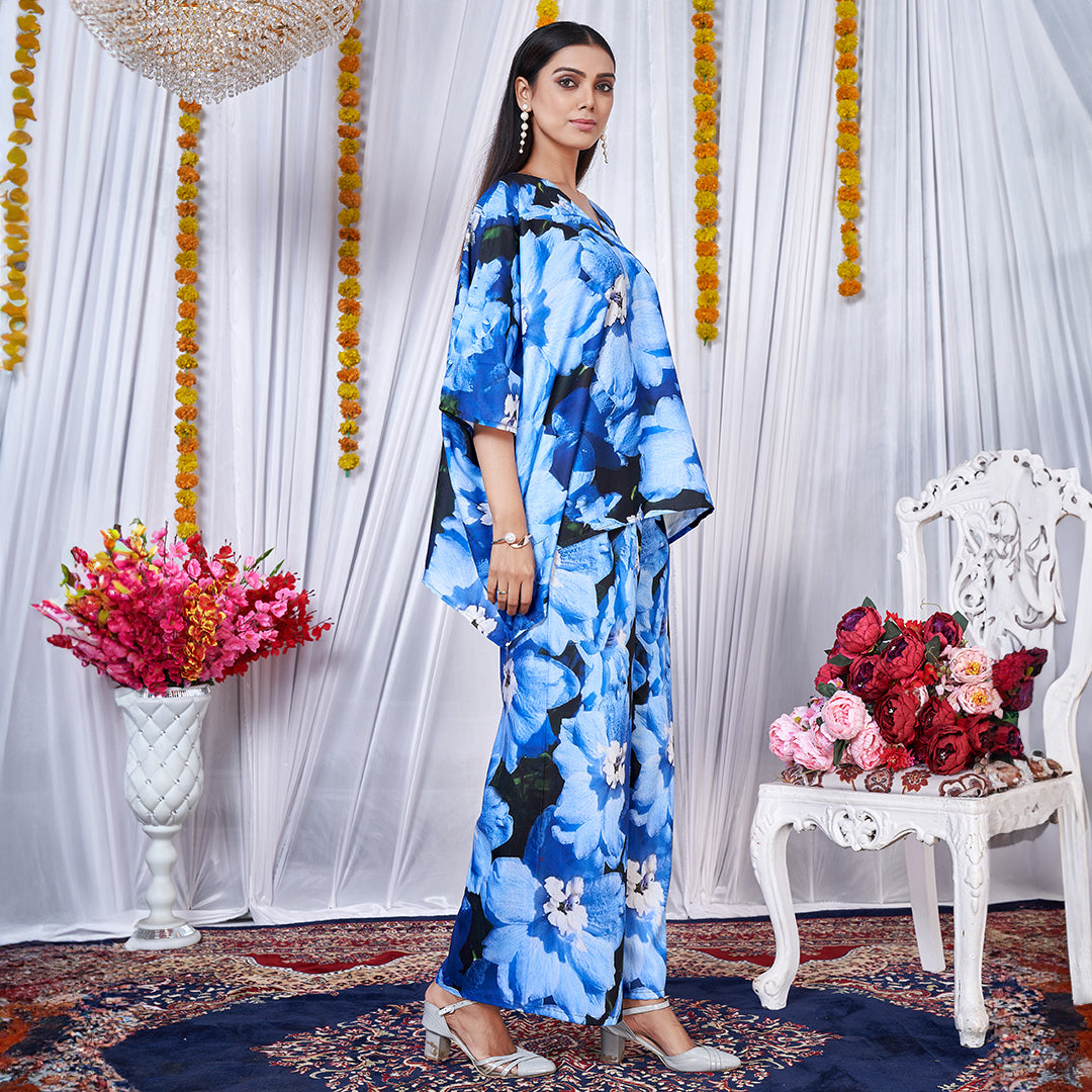 A vibrant floral printed kaftan style co-ord set featuring loose, flowing sleeves and a matching wide-leg bottom for a chic, bohemian look.