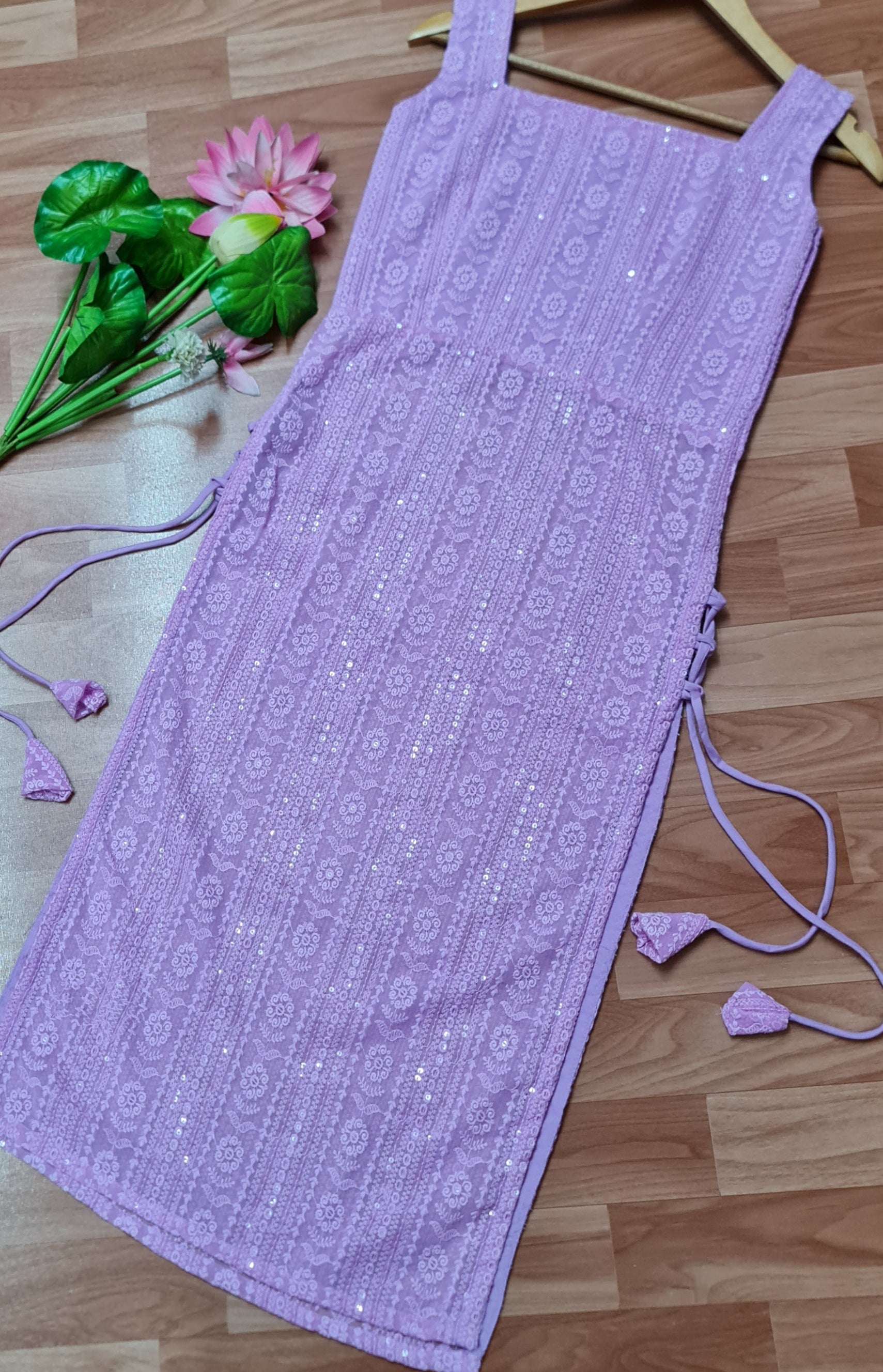 Lavender Chikankari Kurti with Tassels: A long, lavender kurti featuring intricate Chikankari embroidery and delicate side tassels.