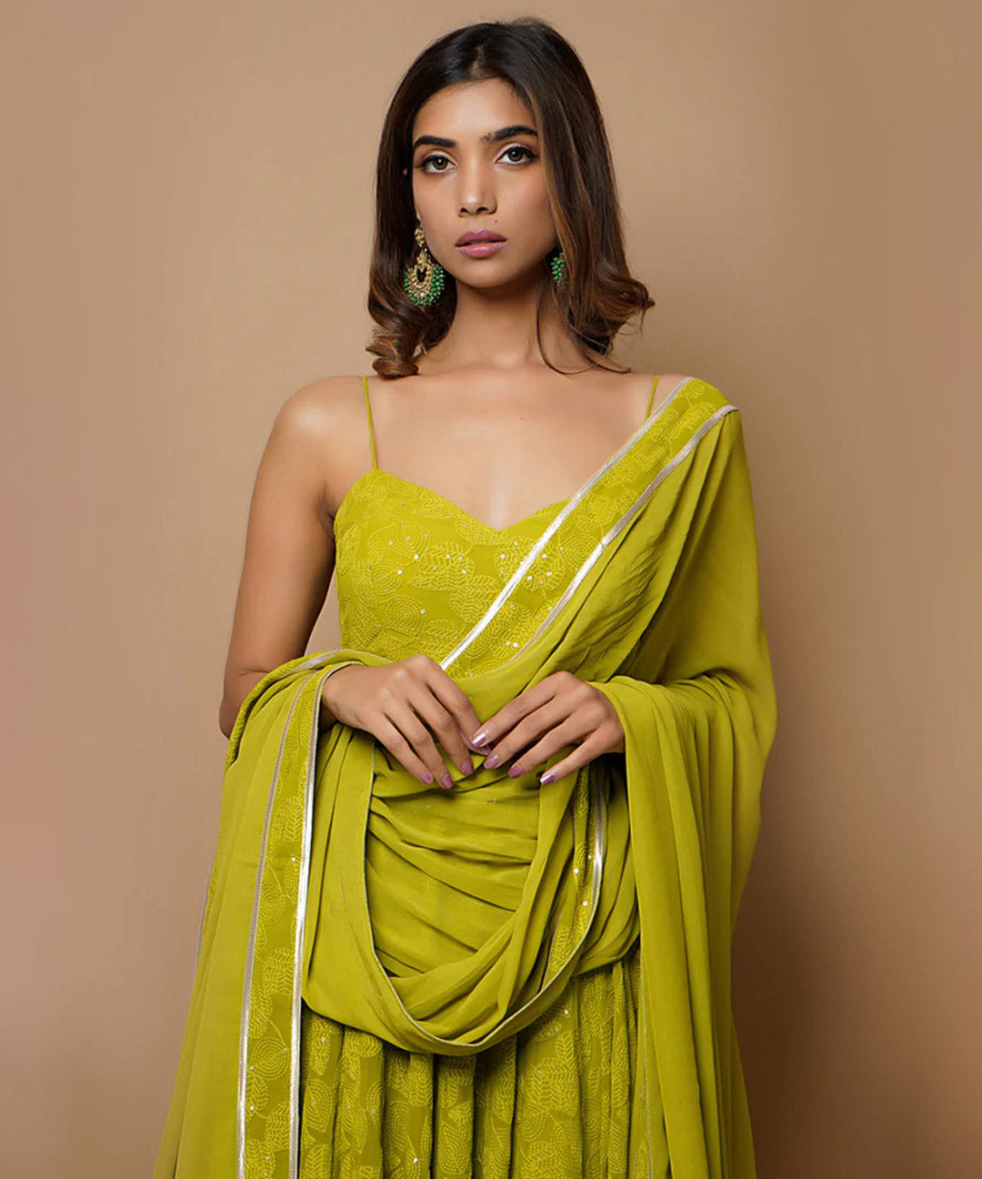 A fully-stitched lime green A-line pant style suit adorned with Lucknowi Chikankari work.