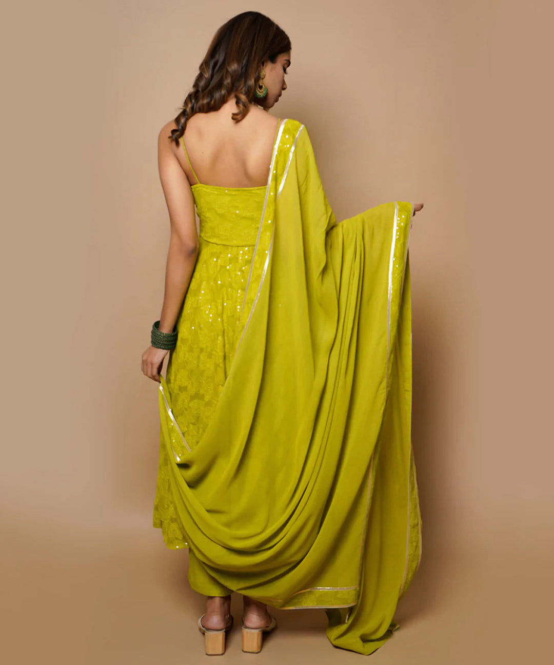 A fully-stitched lime green A-line pant style suit adorned with Lucknowi Chikankari work.