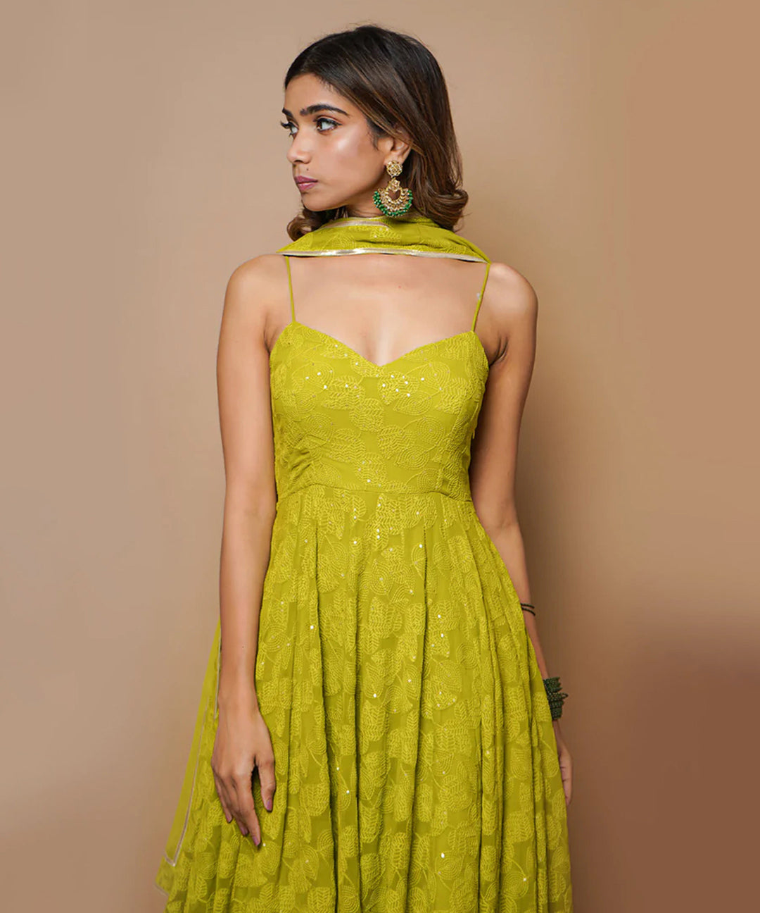 A fully-stitched lime green A-line pant style suit adorned with Lucknowi Chikankari work.