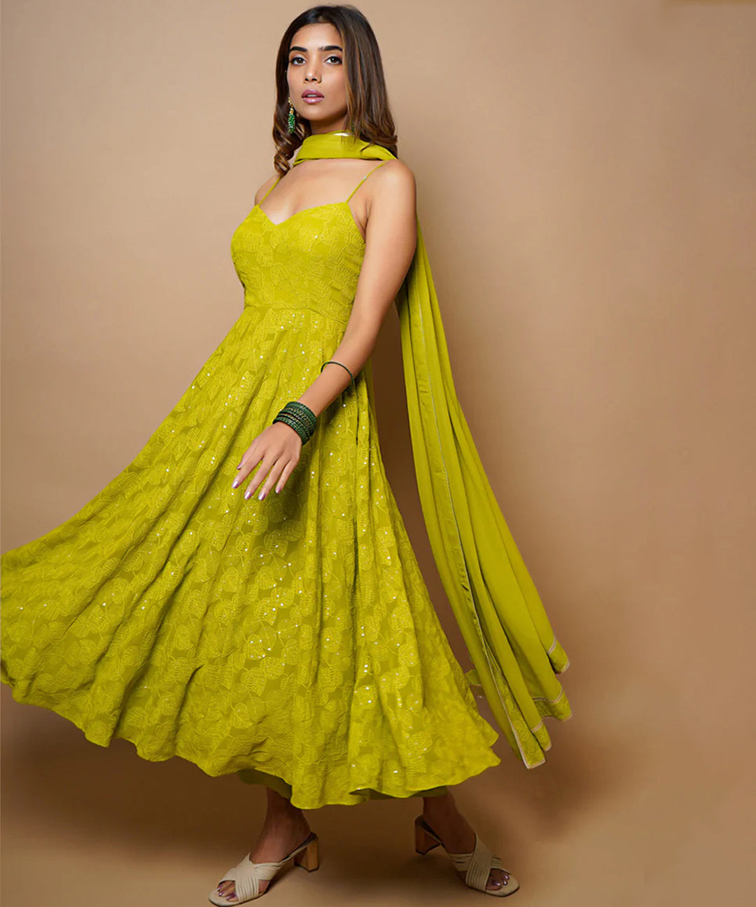 A fully-stitched lime green A-line pant style suit adorned with Lucknowi Chikankari work.