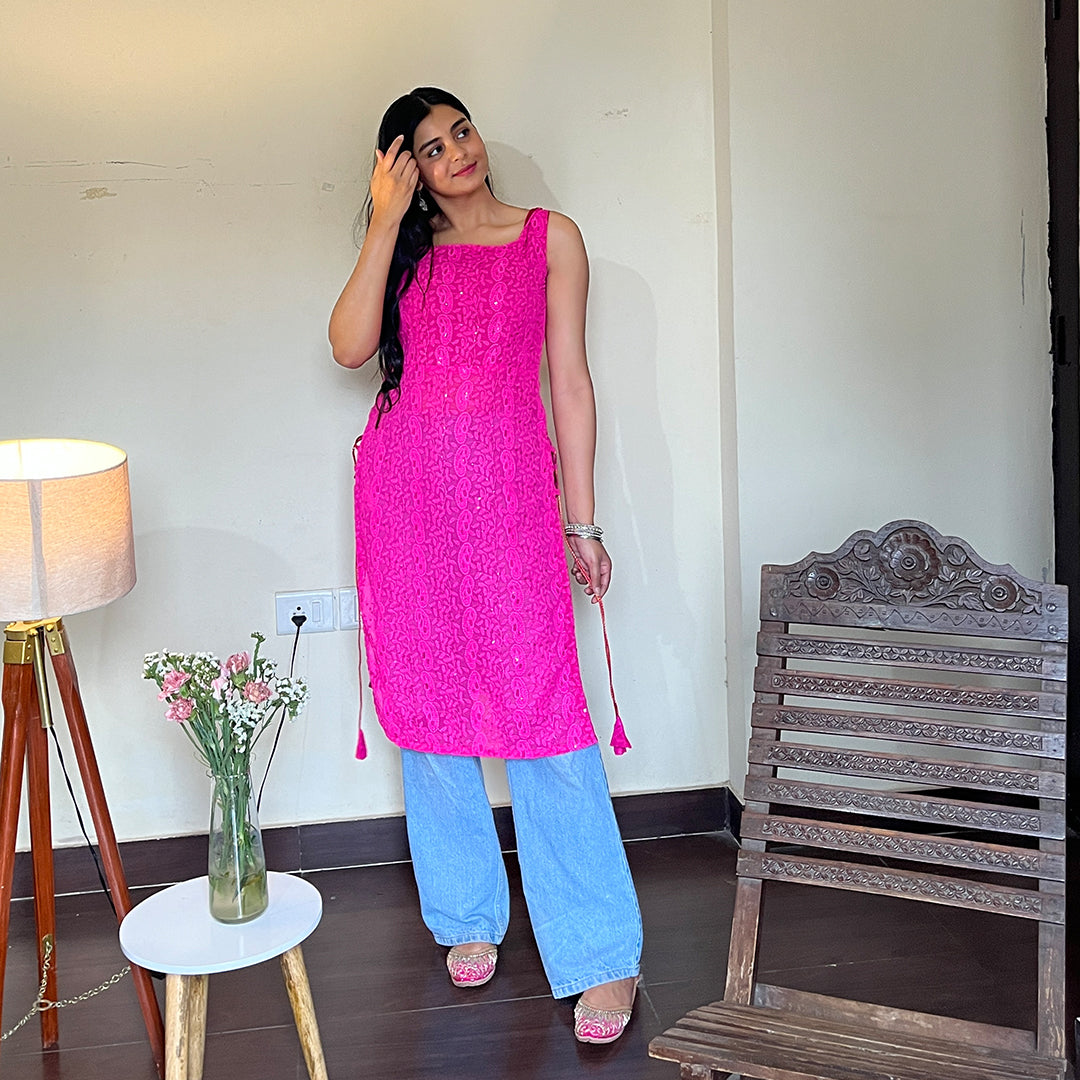 A vibrant magenta georgette kurta with intricate chikankari embroidery and playful side tassels, perfect for adding a touch of elegance and style to any wardrobe.