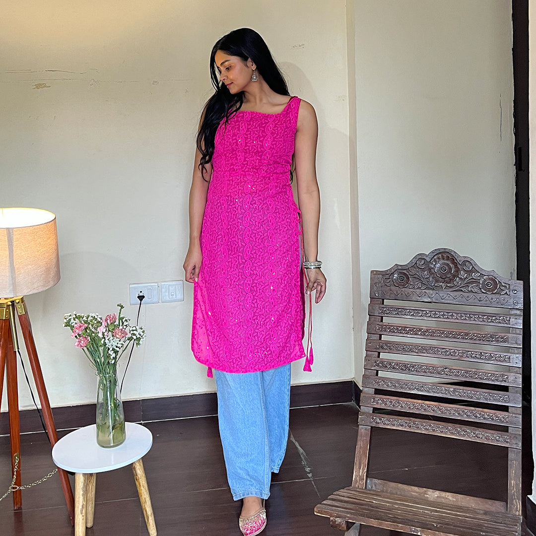 A vibrant magenta georgette kurta with intricate chikankari embroidery and playful side tassels, perfect for adding a touch of elegance and style to any wardrobe.