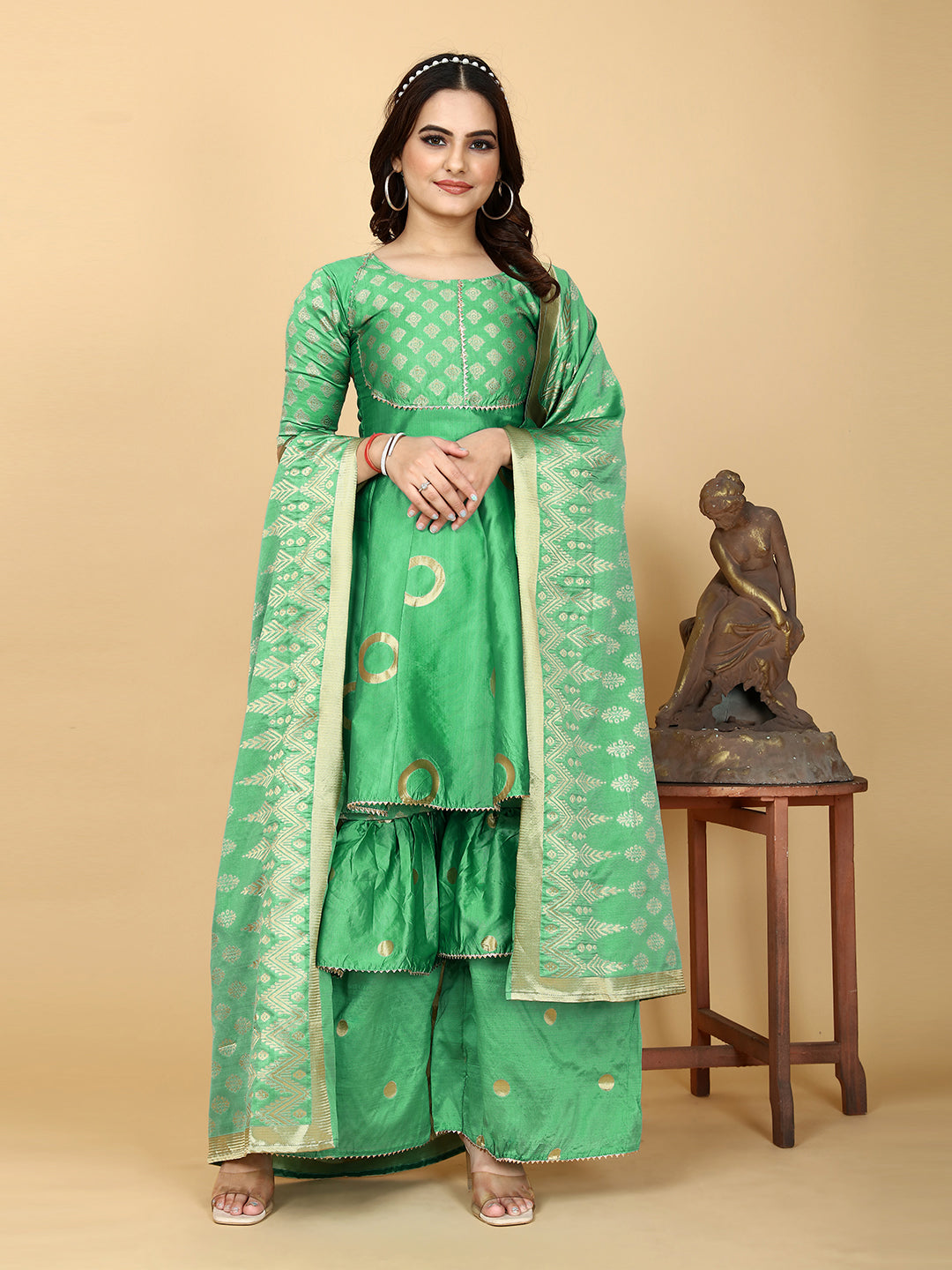 A show-stopping designer sharara set in a mesmerizing shade of magnetic green. Woven for a luxurious feel, this set features a flattering top and wide-leg sharara pants.