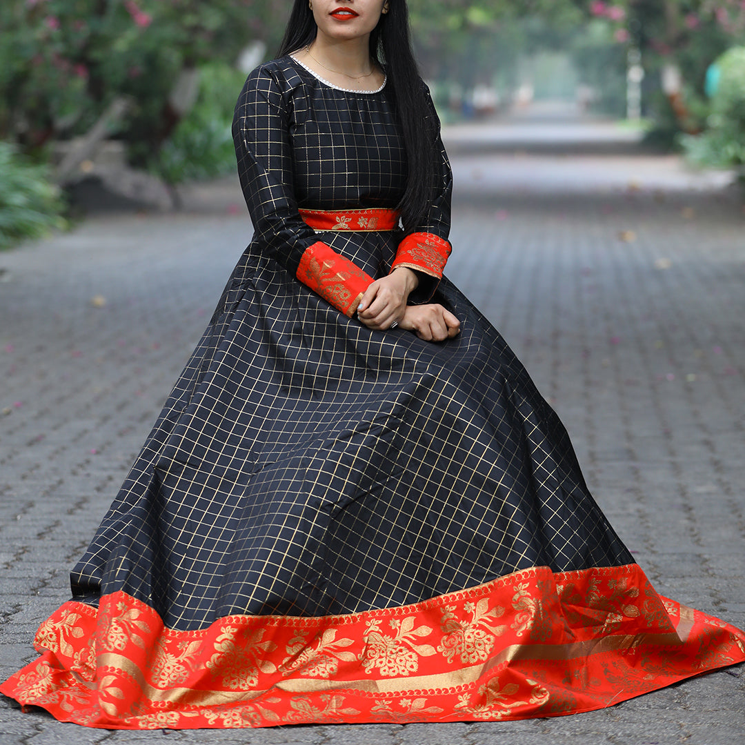 A mesmerizing black gown crafted from luxurious tapetta silk with a captivating jacquard weave, ideal for making a statement at festive events.