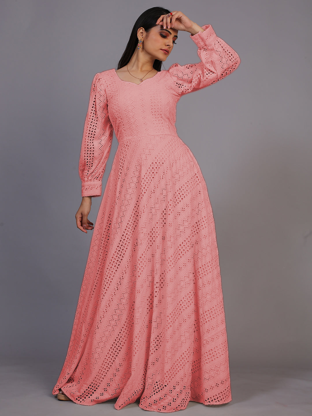 A delicate peach gown featuring beautiful Lucknowi embroidery, cascading down to an elegant floor-length design.