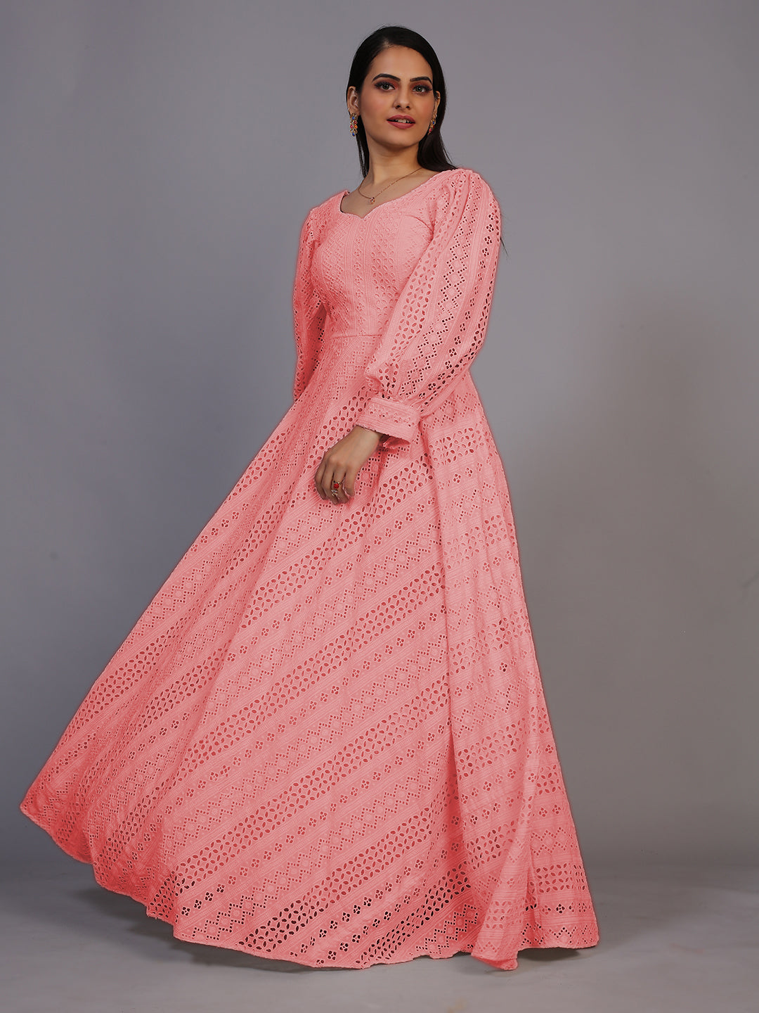 A delicate peach gown featuring beautiful Lucknowi embroidery, cascading down to an elegant floor-length design.
