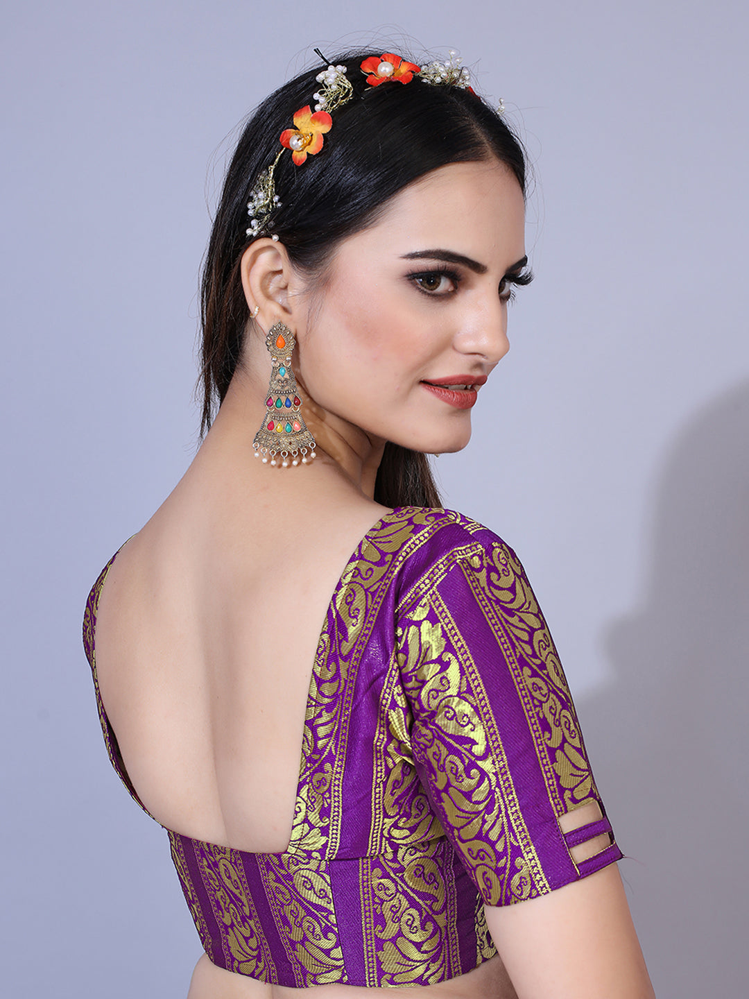 A regal purple lehenga with gold-toned embellishments, paired with a ready-to-wear blouse and matching dupatta. This elegant outfit is perfect for a festive occasion.