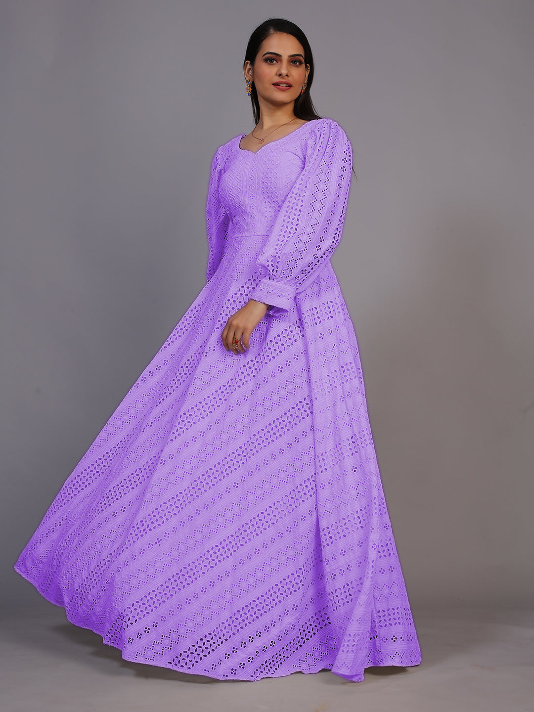 A stunning floor-length gown in rich purple, adorned with intricate Lucknowi embroidery.
