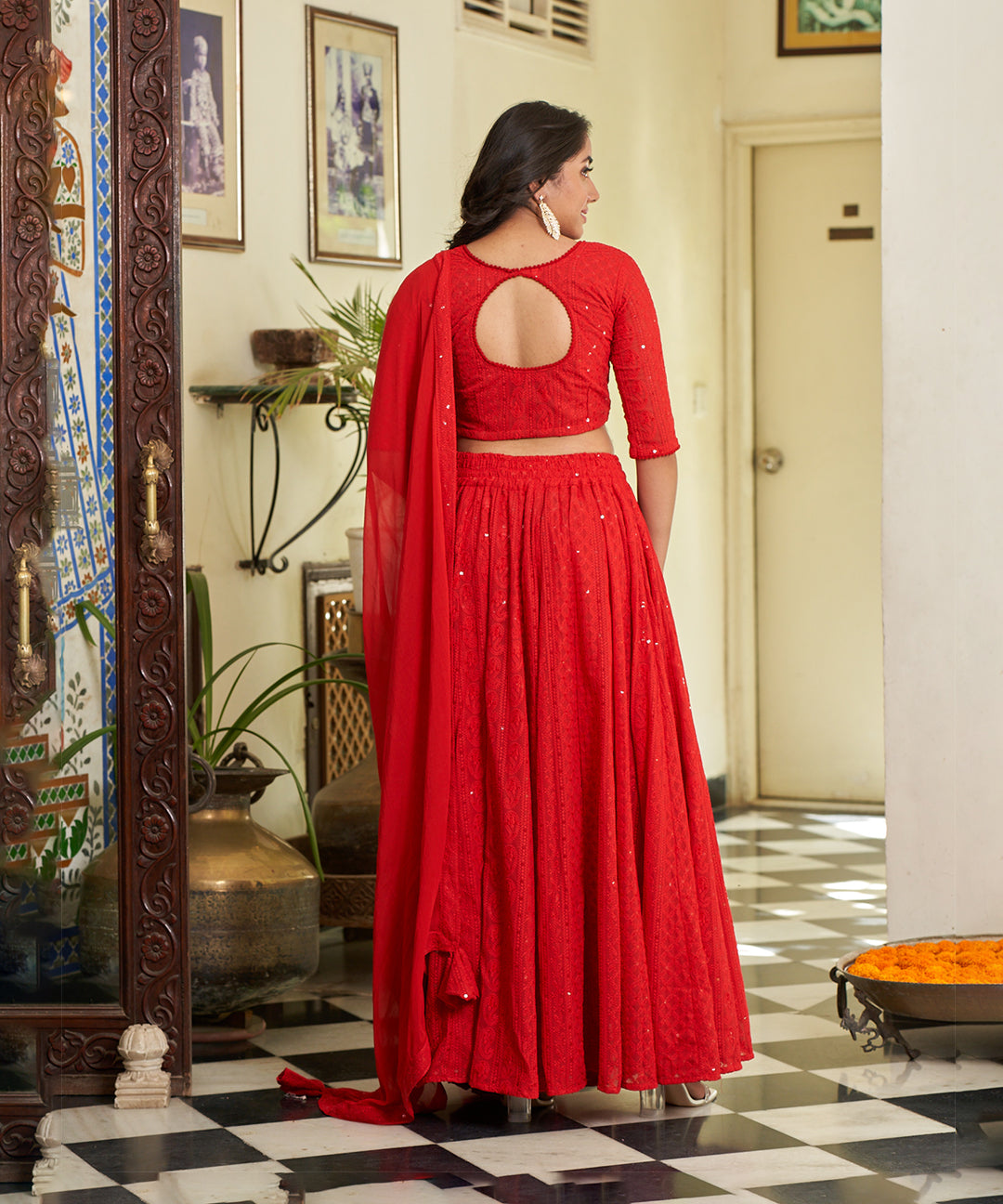 Red A-line lehenga choli with Lucknowi Chikankari work, showcasing intricate embroidery and an elegant design