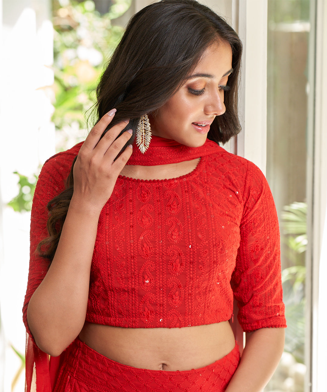 Red A-line lehenga choli with Lucknowi Chikankari work, showcasing intricate embroidery and an elegant design