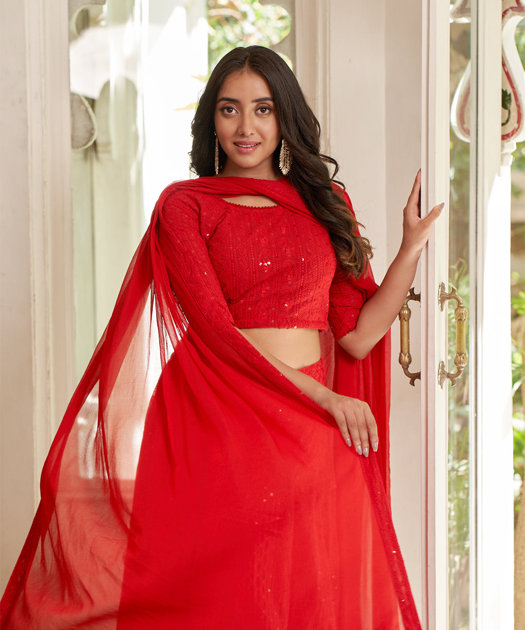 Red A-line lehenga choli with Lucknowi Chikankari work, showcasing intricate embroidery and an elegant design