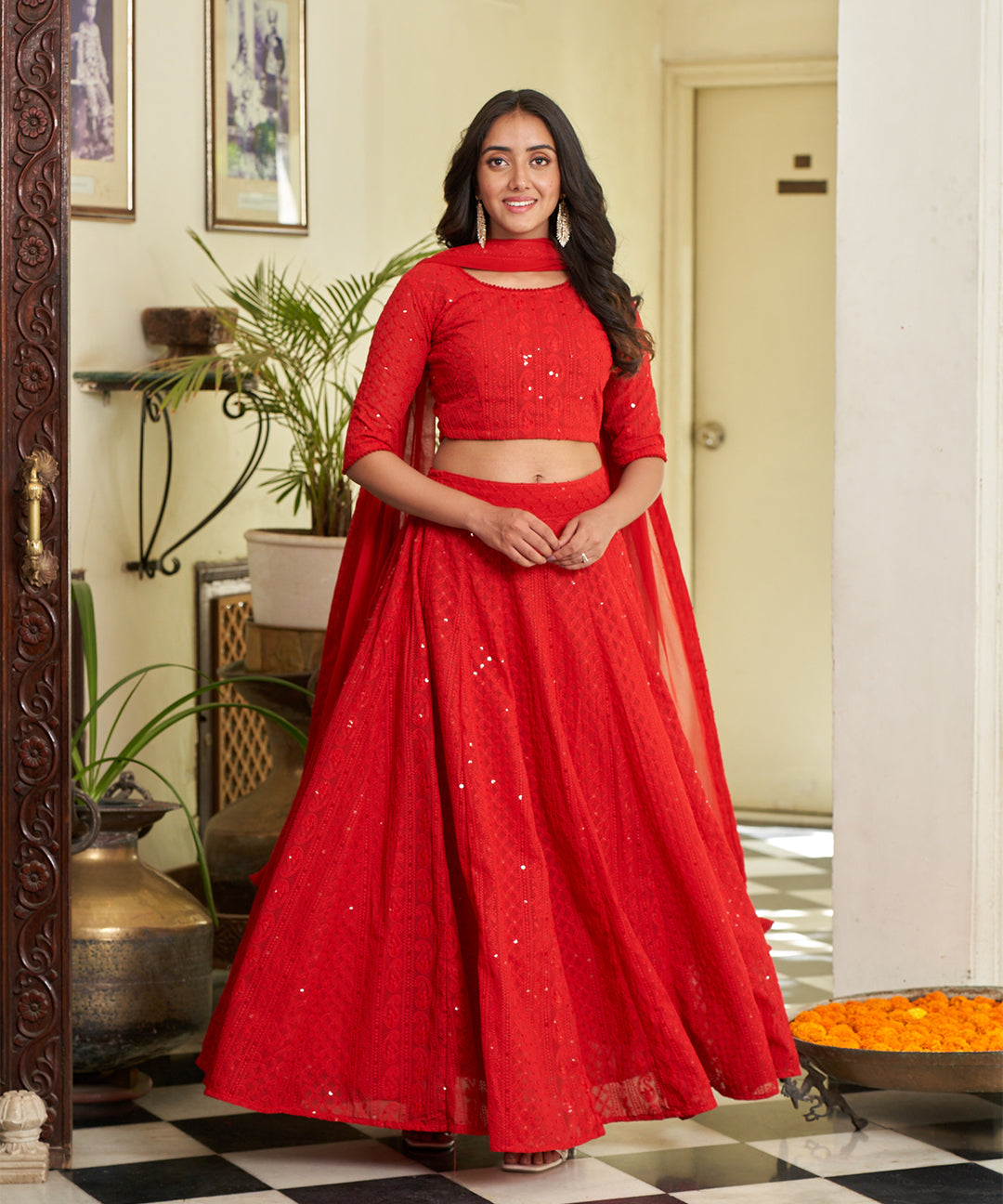 Red A-line lehenga choli with Lucknowi Chikankari work, showcasing intricate embroidery and an elegant design