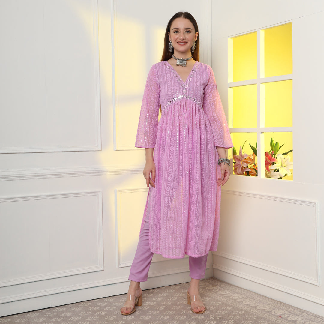 "An enchanting floral mirror work kurta set, harmonizing blooms and sparkling details."
