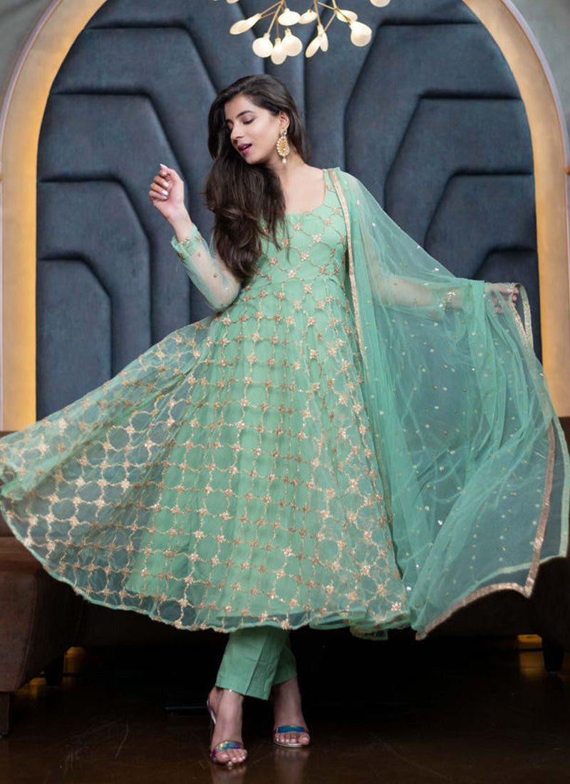 Beautiful turquoise dress with intricate coding embroidery and elegant silk pants.