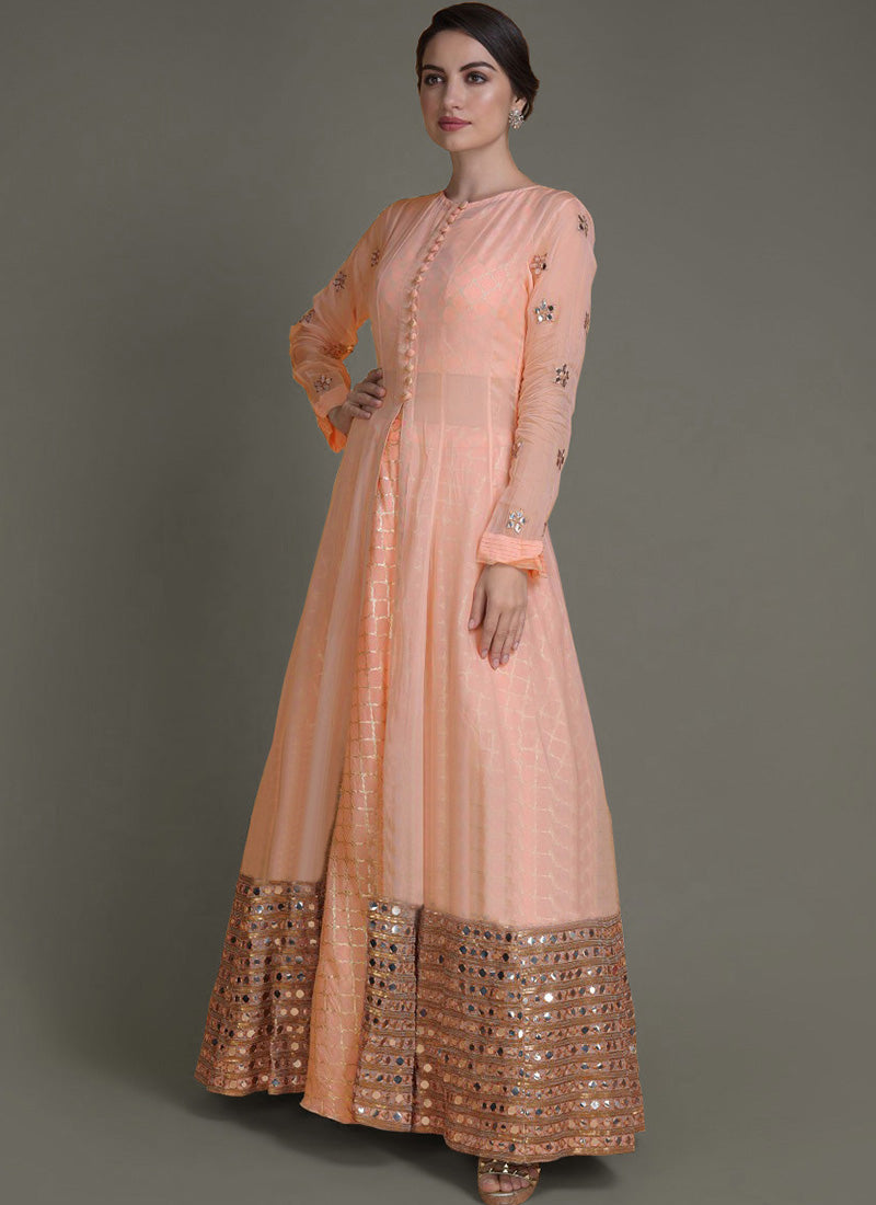 Peach designer lehenga with jacket, featuring shimmering mirror work and contrasting woven skirt panels.
