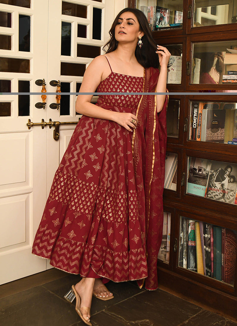 Magnetic maroon colored partywear stitched woven jacquard suit set, perfect for elegant and celebratory occasions.