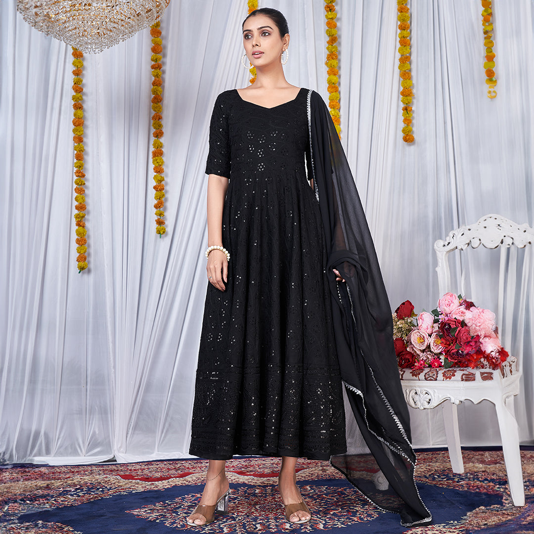 A black gown featuring intricate Chikankari and embroidery work.