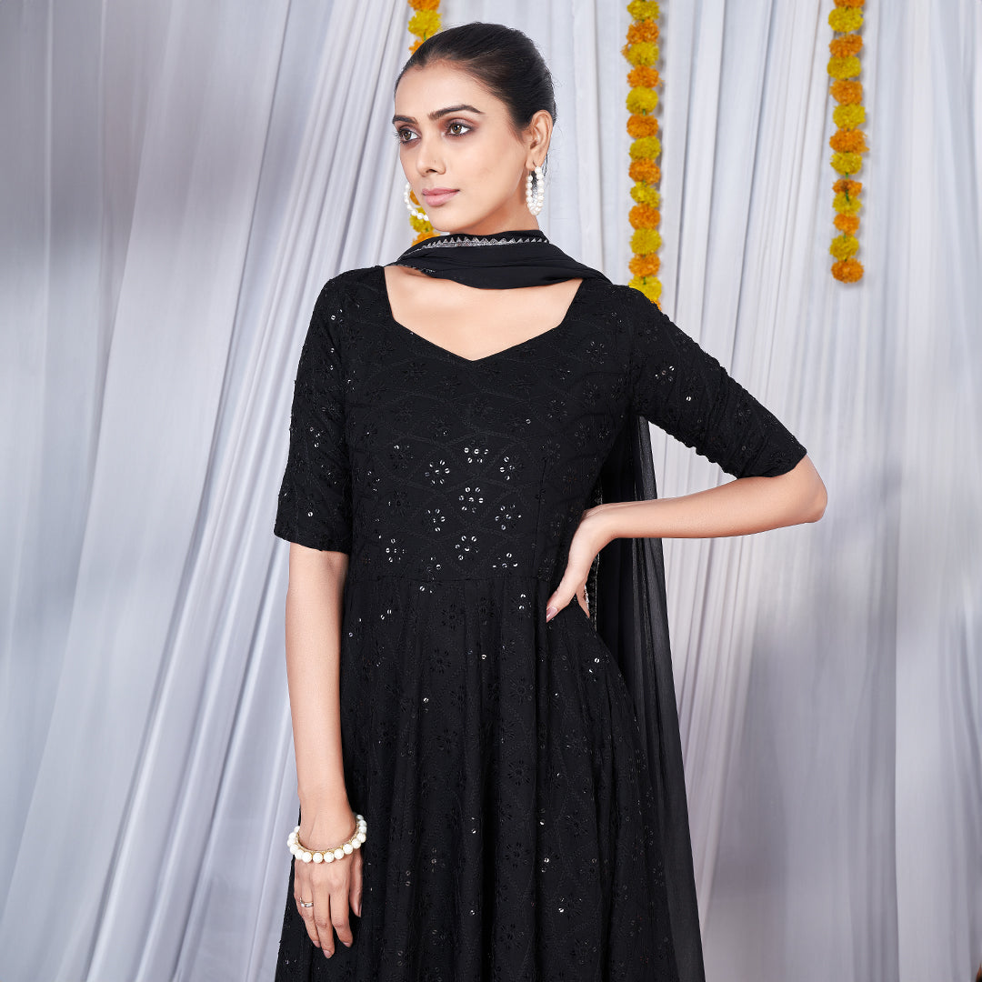 A black gown featuring intricate Chikankari and embroidery work.