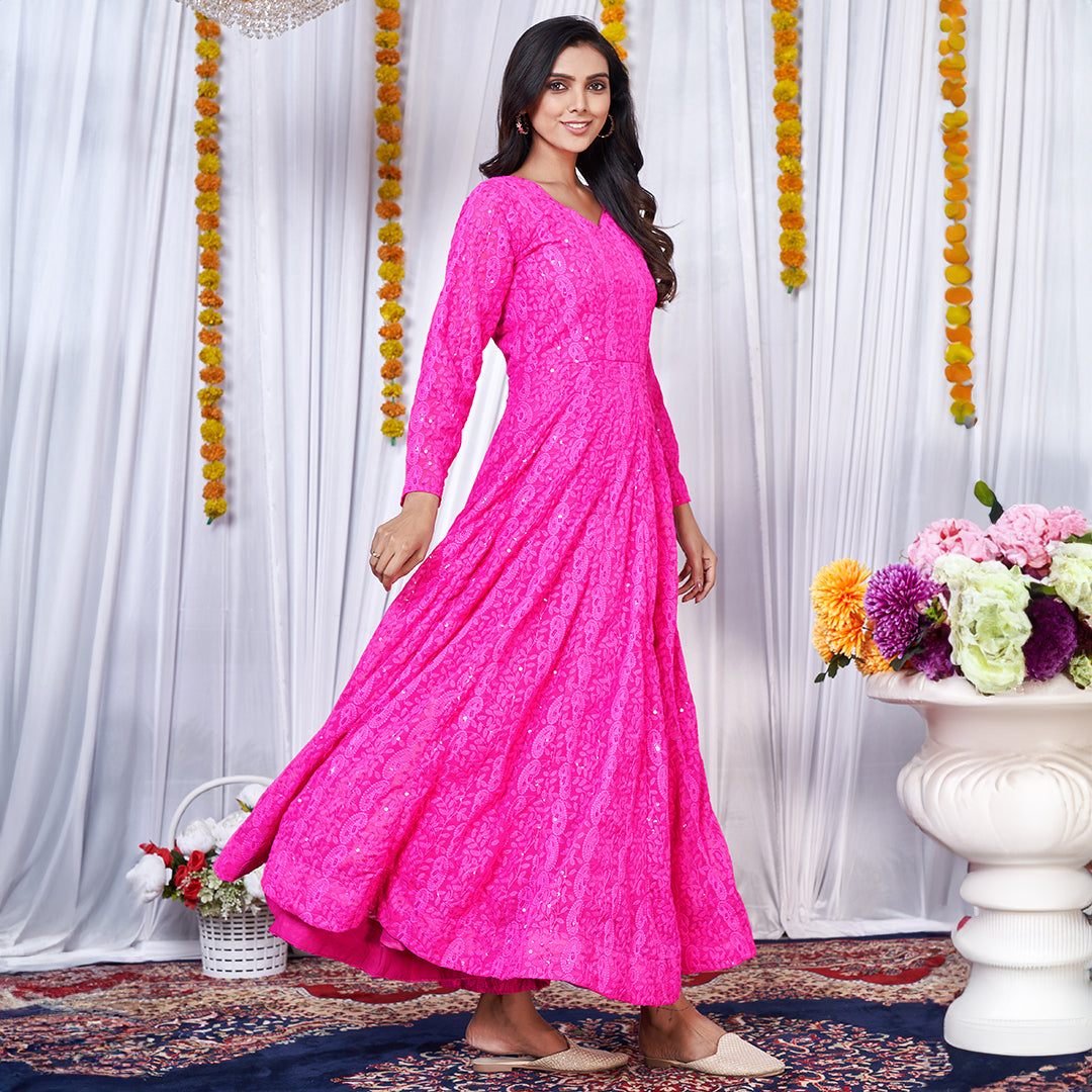 A dark pink georgette gown adorned with intricate Lucknowi embroidery.