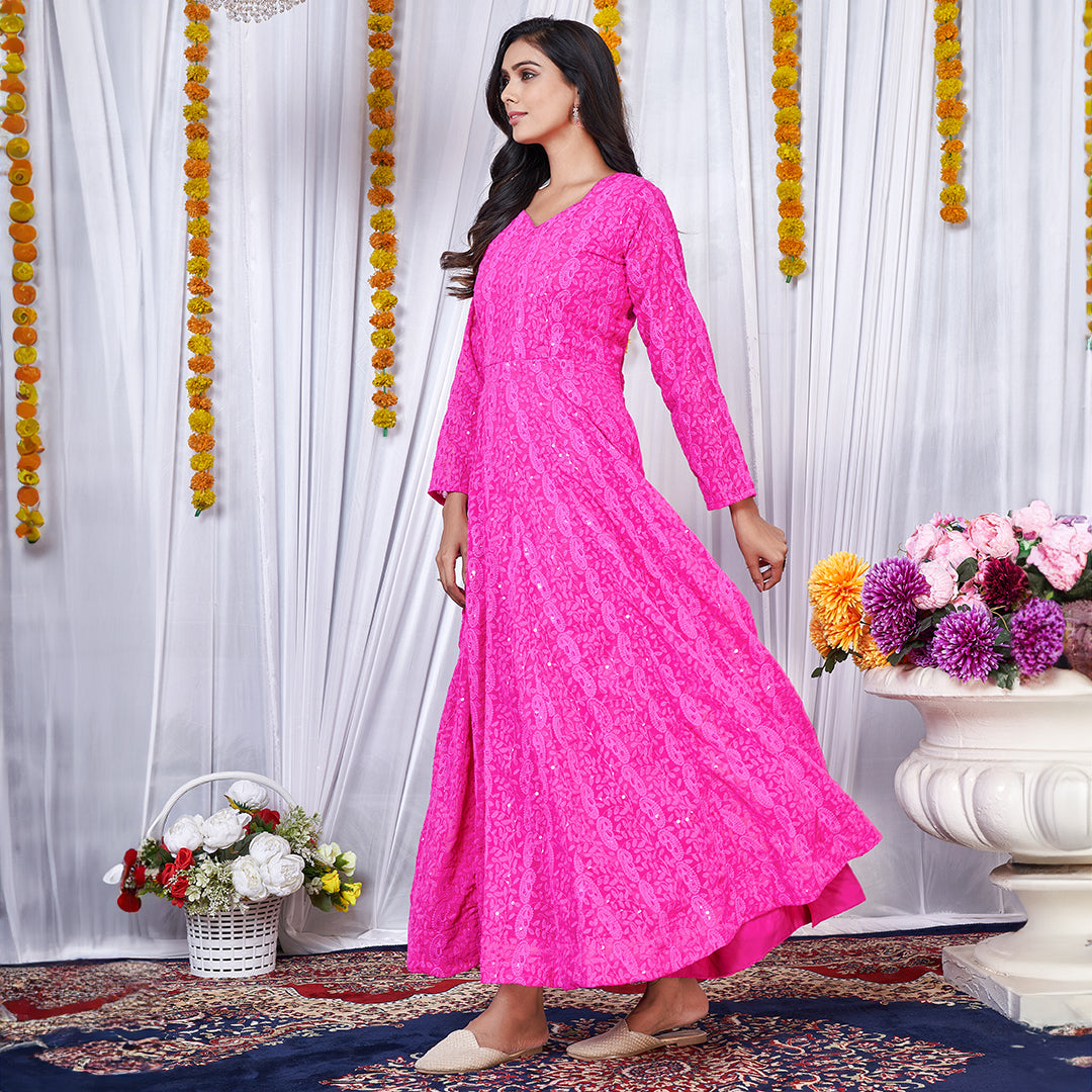 A dark pink georgette gown adorned with intricate Lucknowi embroidery.