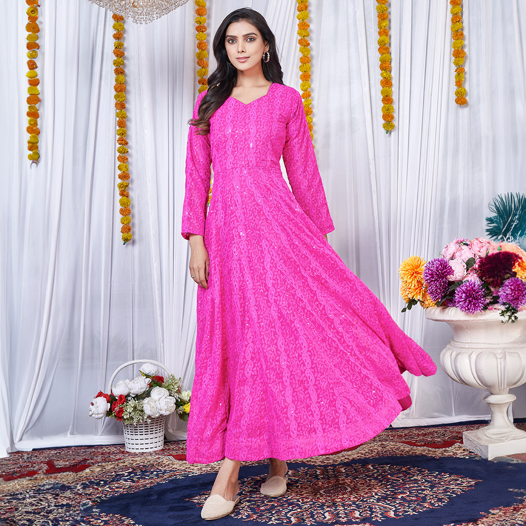 A dark pink georgette gown adorned with intricate Lucknowi embroidery.