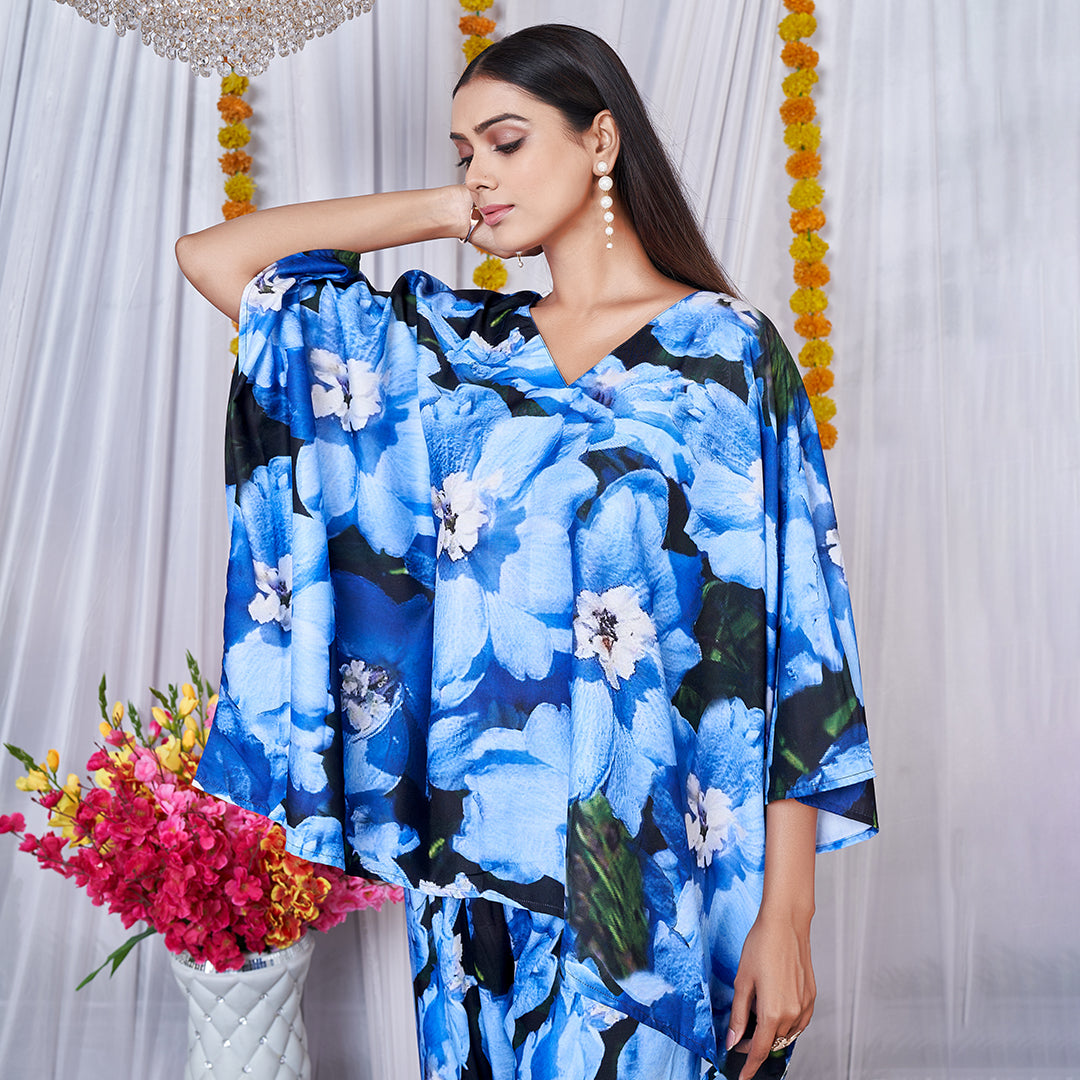 A vibrant floral printed kaftan style co-ord set featuring loose, flowing sleeves and a matching wide-leg bottom for a chic, bohemian look.