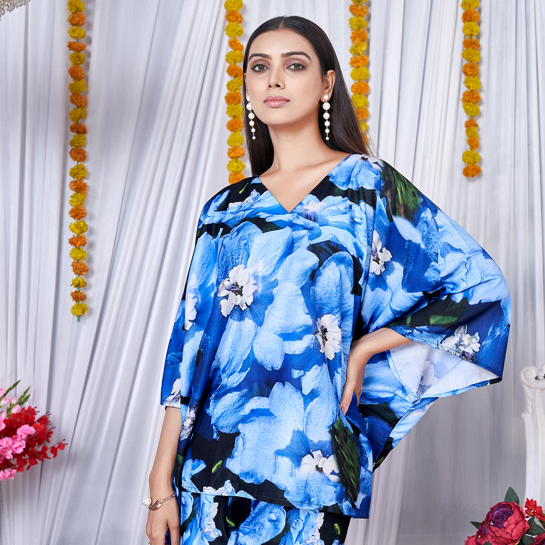 A vibrant floral printed kaftan style co-ord set featuring loose, flowing sleeves and a matching wide-leg bottom for a chic, bohemian look.