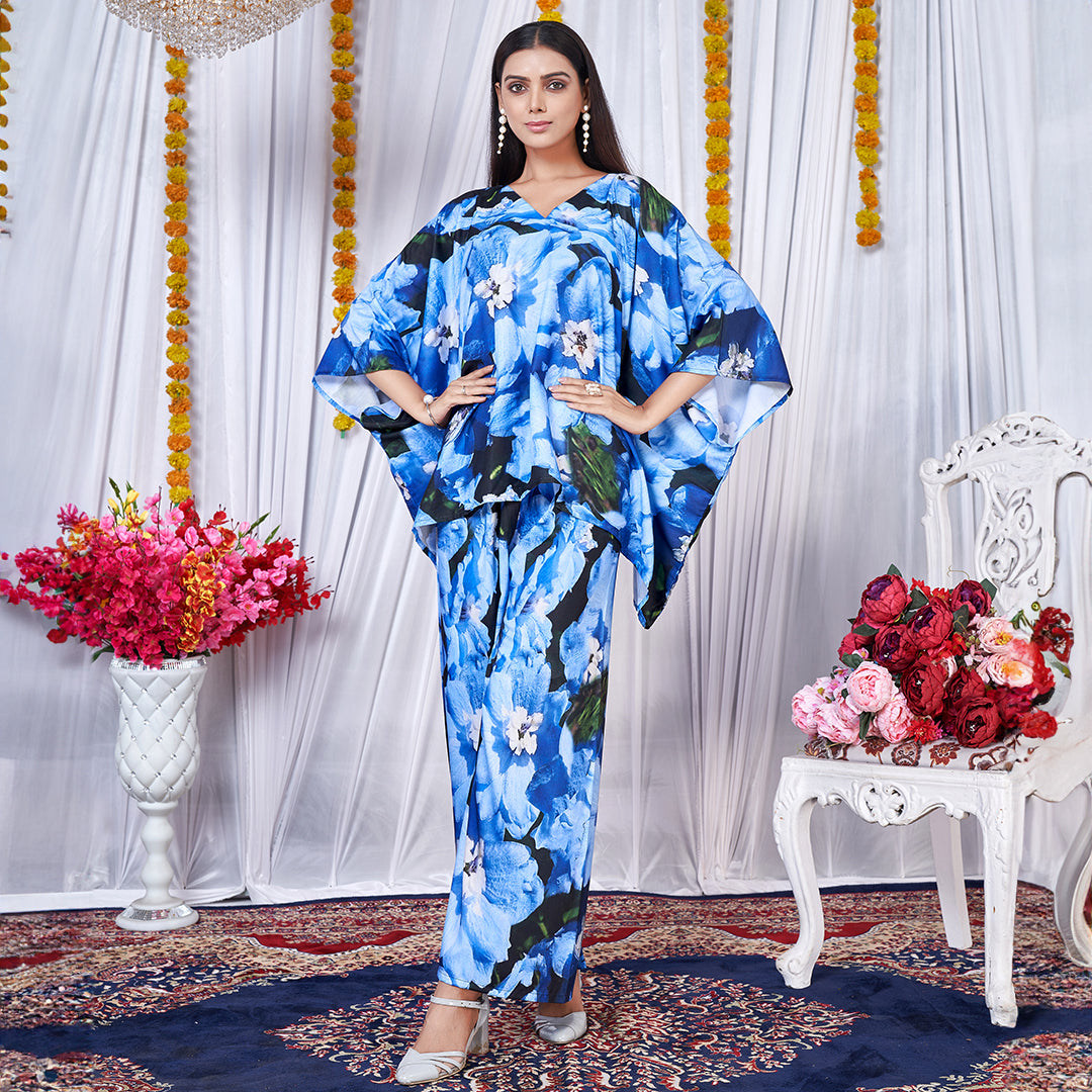 A vibrant floral printed kaftan style co-ord set featuring loose, flowing sleeves and a matching wide-leg bottom for a chic, bohemian look.