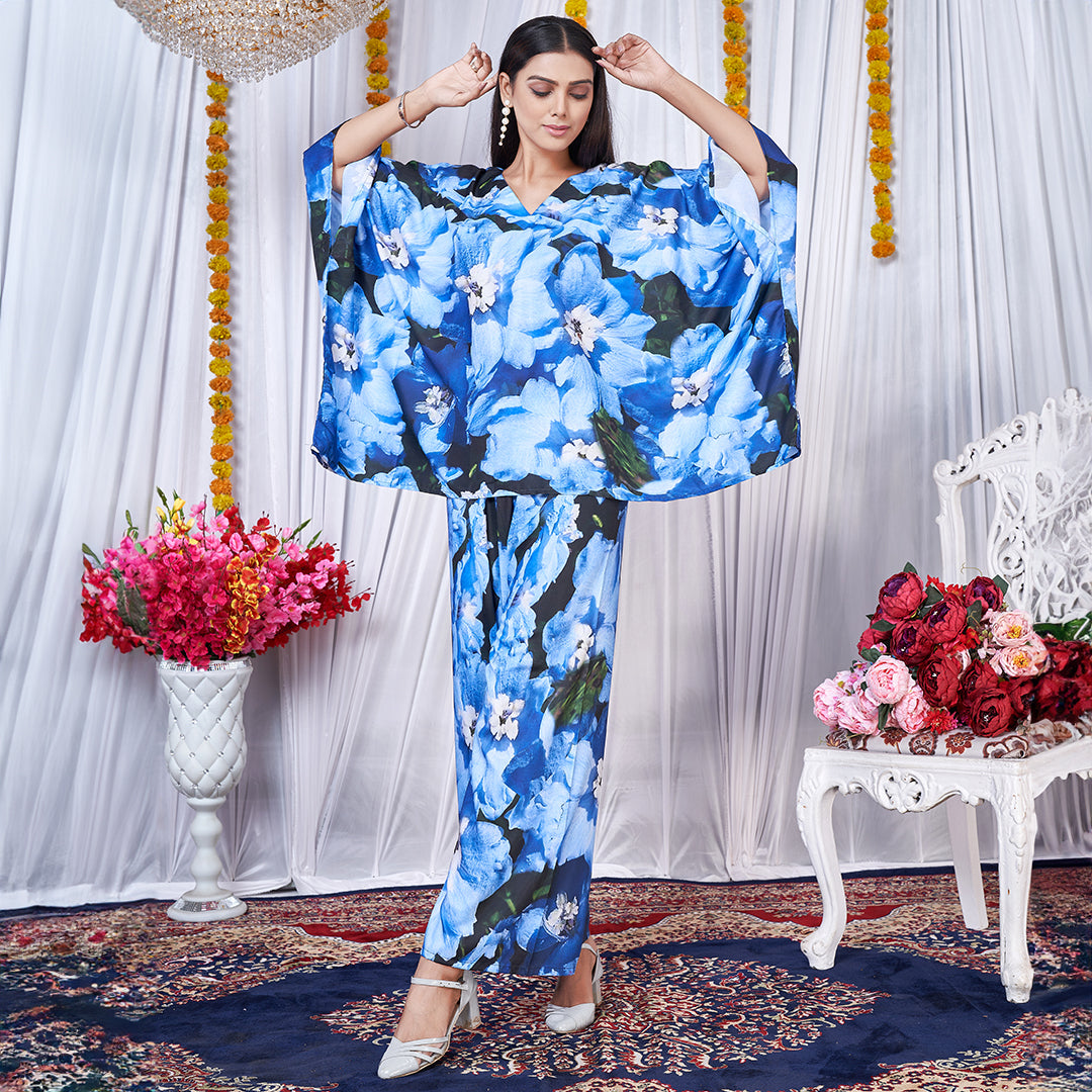 A vibrant floral printed kaftan style co-ord set featuring loose, flowing sleeves and a matching wide-leg bottom for a chic, bohemian look.