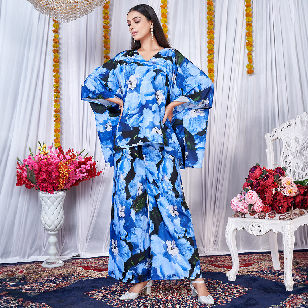 A vibrant floral printed kaftan style co-ord set featuring loose, flowing sleeves and a matching wide-leg bottom for a chic, bohemian look.