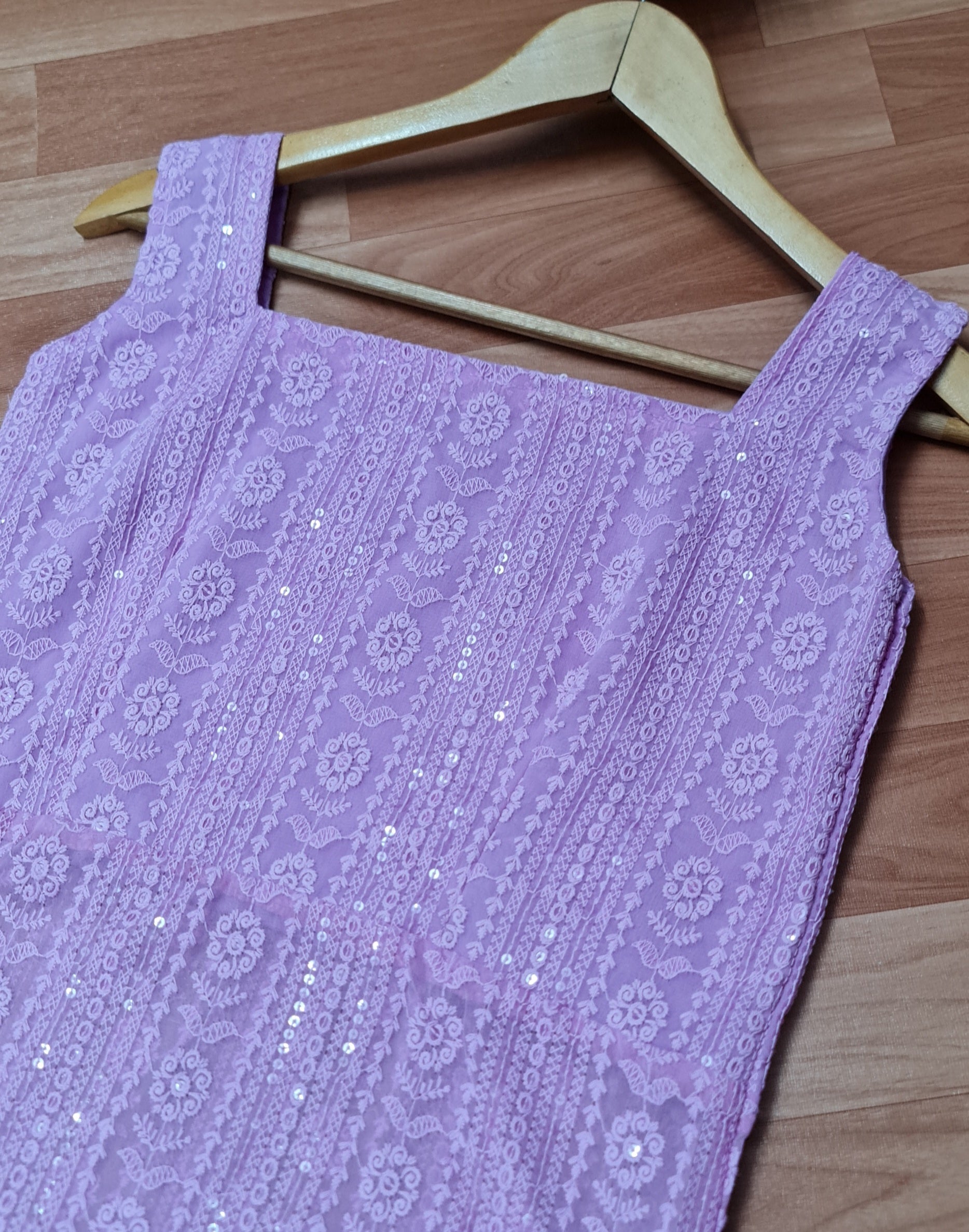 Lavender Chikankari Kurti with Tassels: A long, lavender kurti featuring intricate Chikankari embroidery and delicate side tassels.