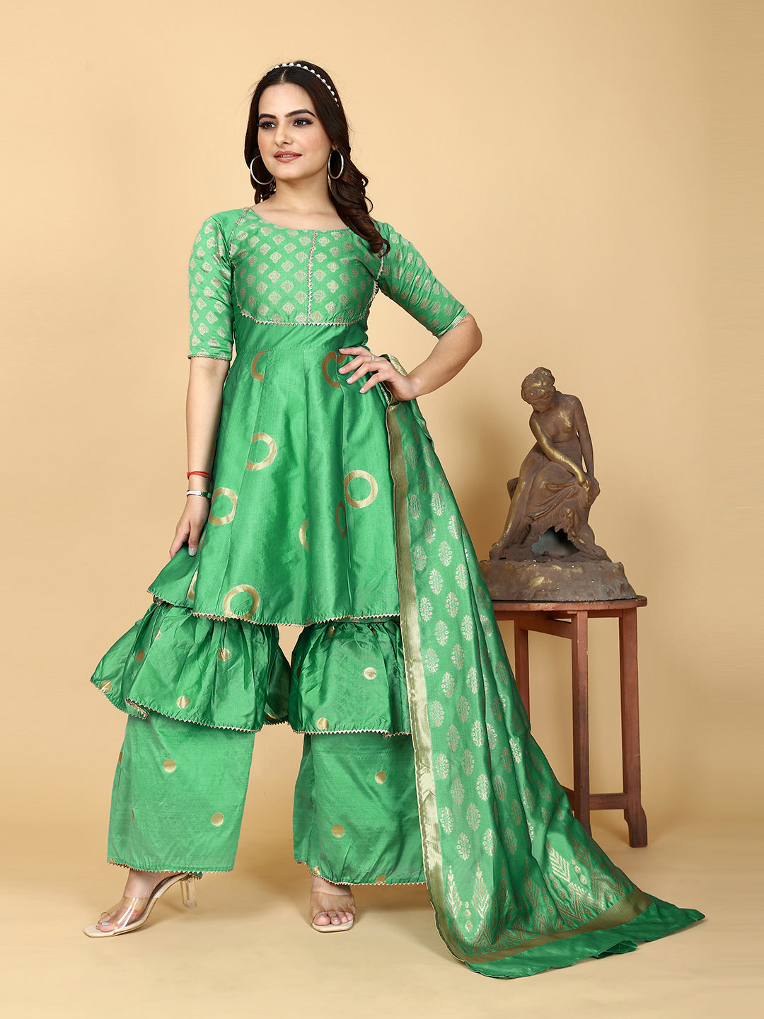 A show-stopping designer sharara set in a mesmerizing shade of magnetic green. Woven for a luxurious feel, this set features a flattering top and wide-leg sharara pants.