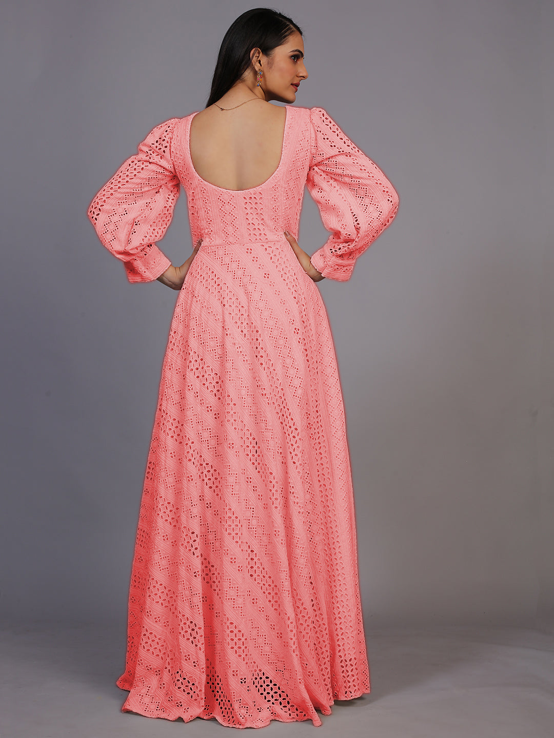 A delicate peach gown featuring beautiful Lucknowi embroidery, cascading down to an elegant floor-length design.