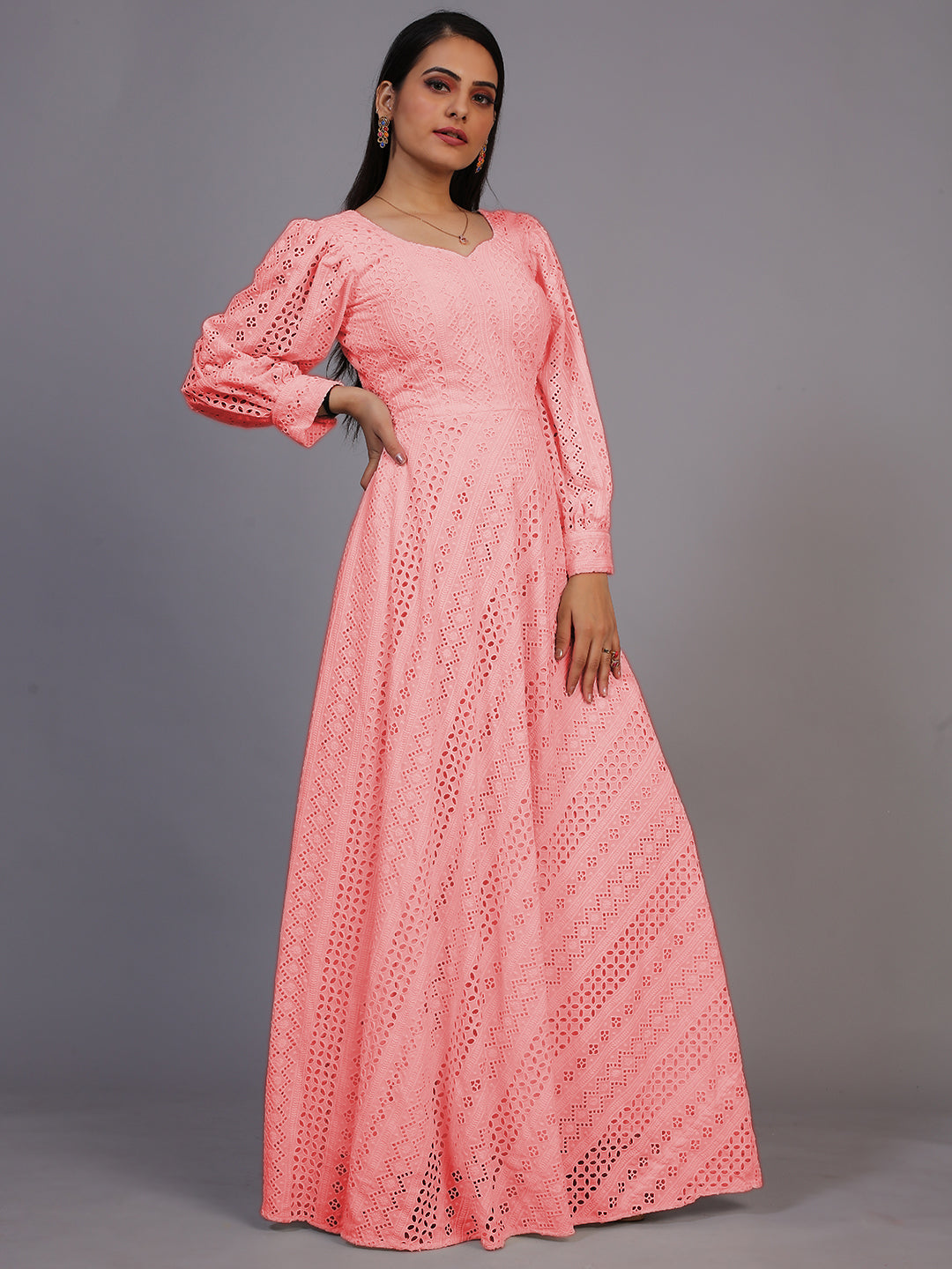 A delicate peach gown featuring beautiful Lucknowi embroidery, cascading down to an elegant floor-length design.