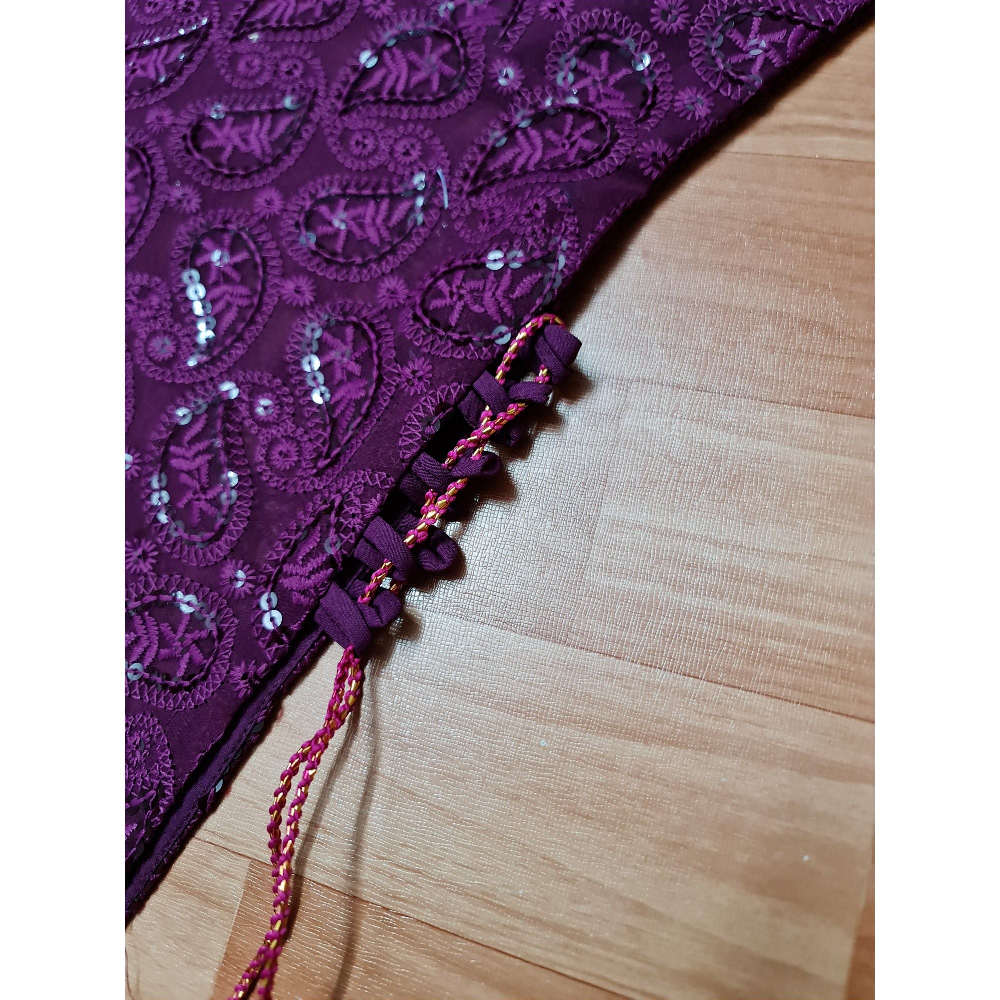 A stunning long kurta in a captivating shade of purple, adorned with intricate Chikankari embroidery and stylish side tassels.