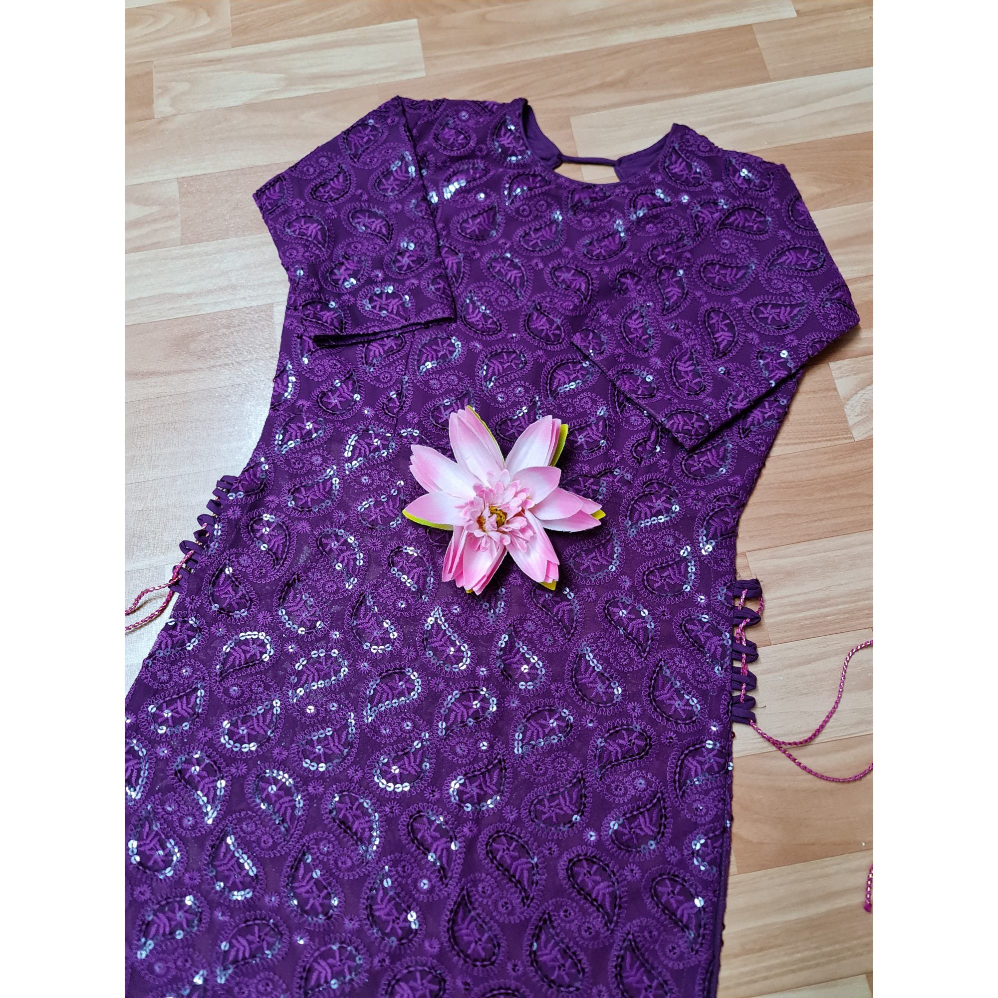 A stunning long kurta in a captivating shade of purple, adorned with intricate Chikankari embroidery and stylish side tassels.